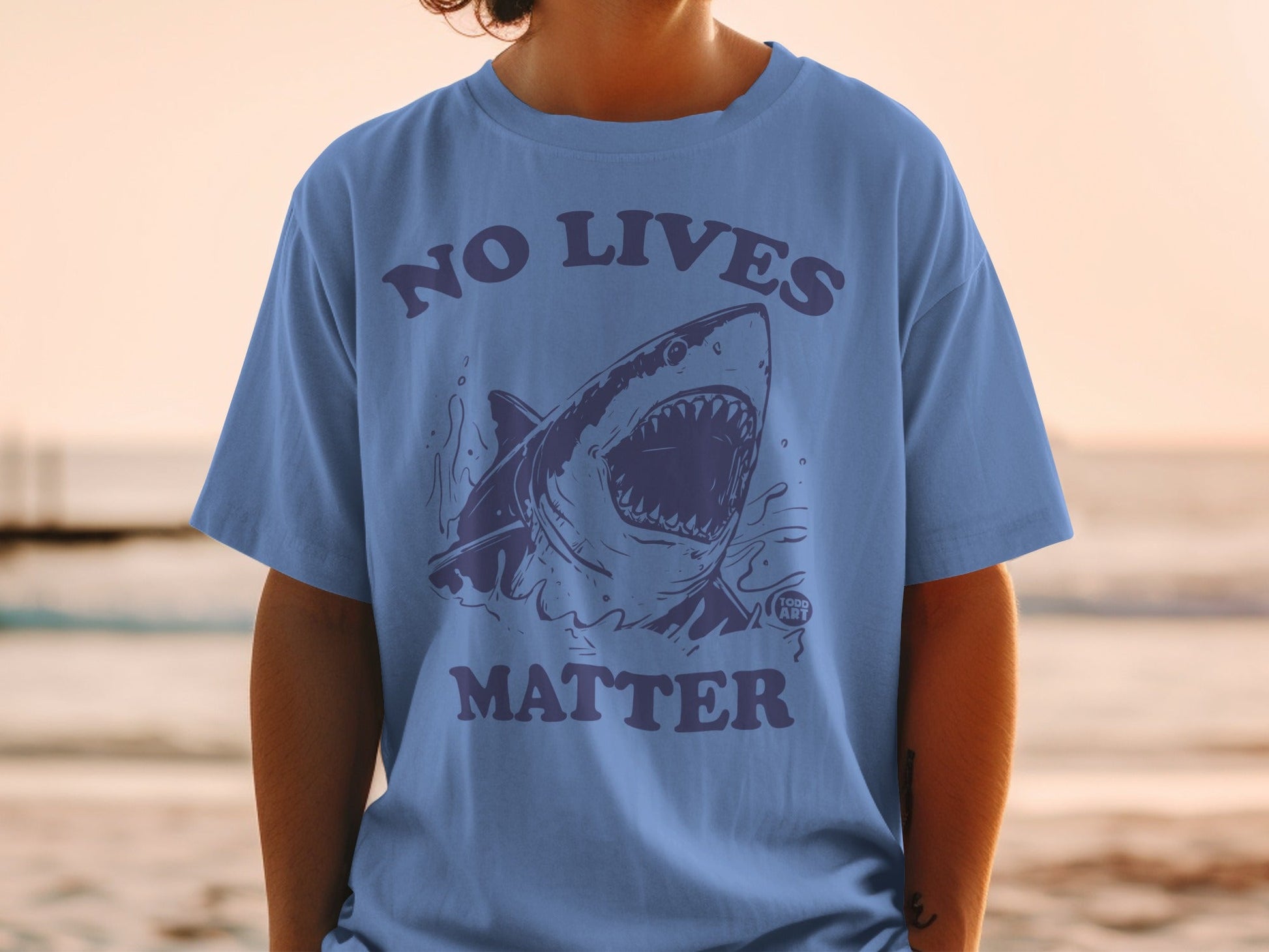 Shirt with shark graphic and text "NO LIVES MATTER".
