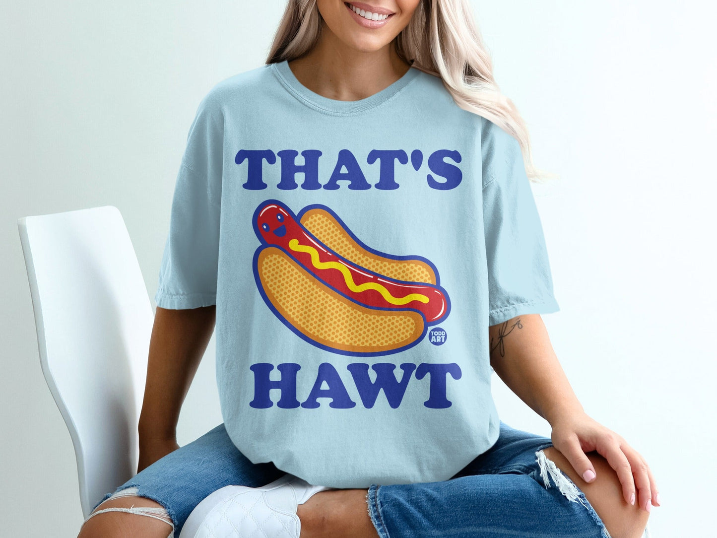 Light blue t-shirt with a cartoon hot dog graphic and text "THAT'S HAWT".