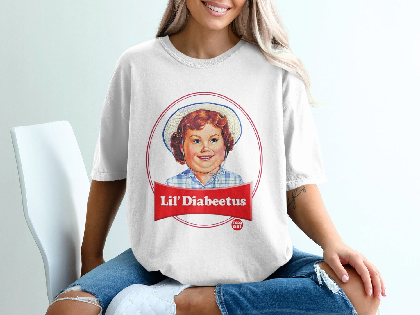 White t-shirt with red and blue "Lil' Diabeetus" cartoon child graphic.