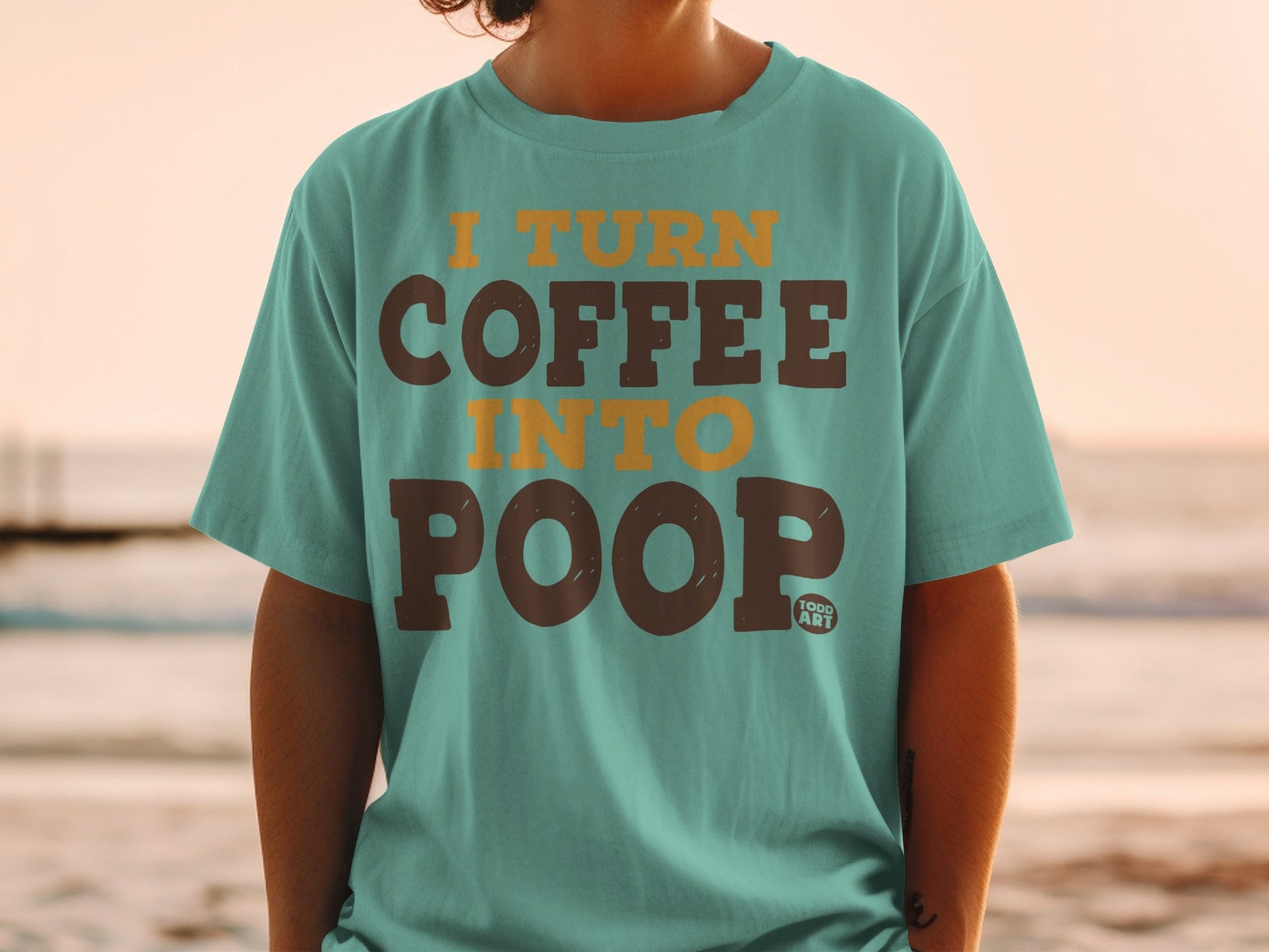 Teal t-shirt with "I TURN COFFEE INTO POOP" text and "TODD ART" logo.