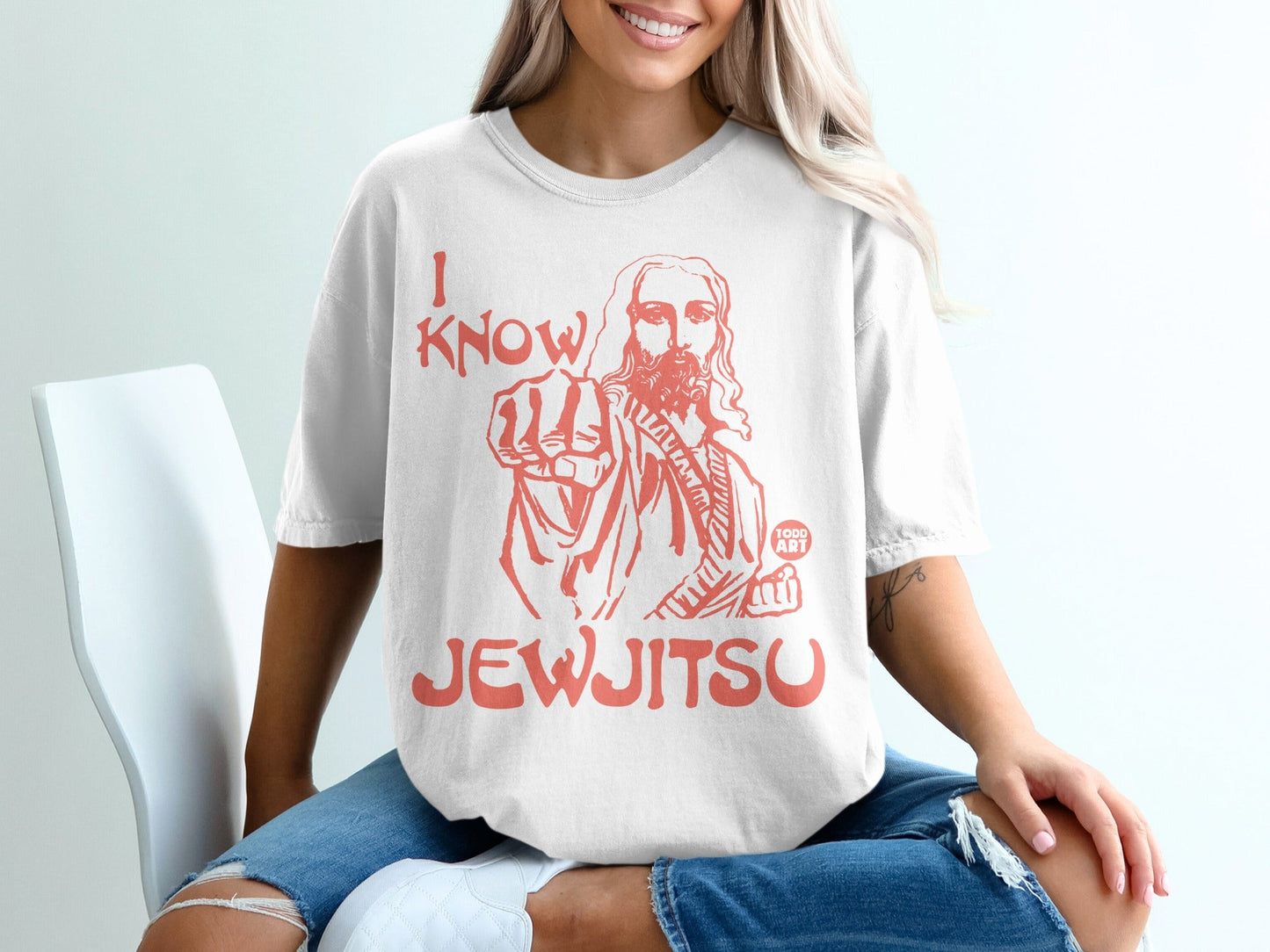 White t-shirt with red graphic of Jesus pointing and the text "I KNOW JEW-JITSU".