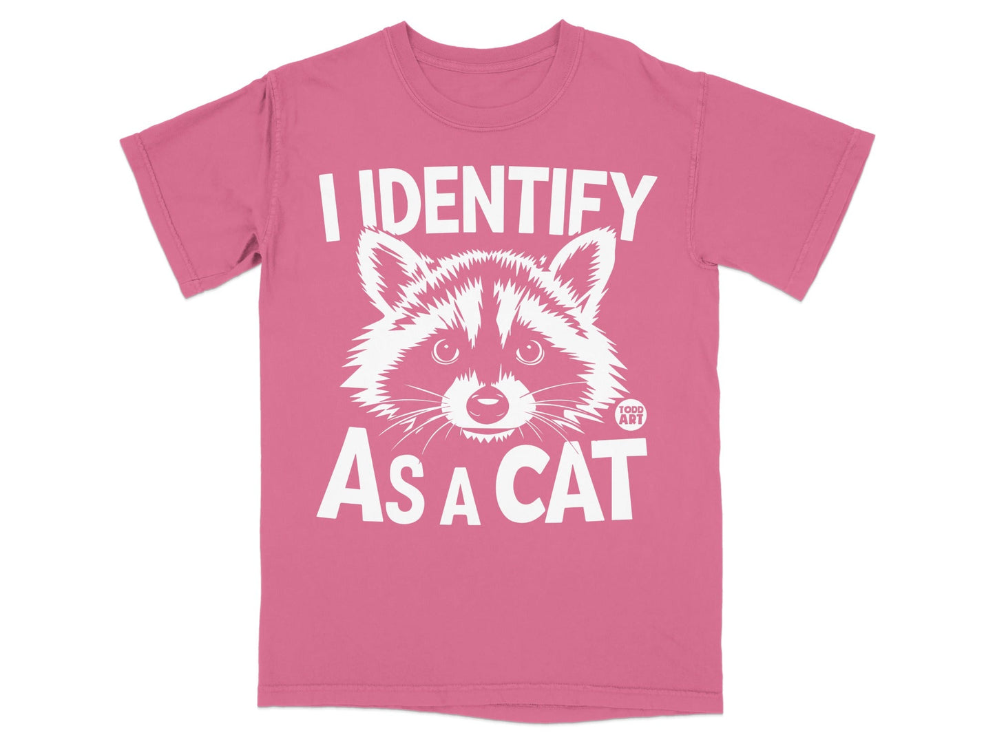 Pink t-shirt with a raccoon graphic and text "I IDENTIFY AS A CAT".