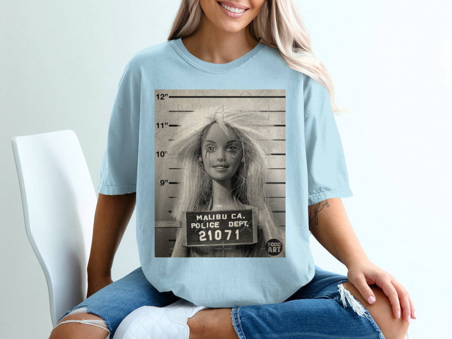 Mugshot of a Barbie doll with "Malibu Ca. Police Dept. 21071 Todd Art" text.