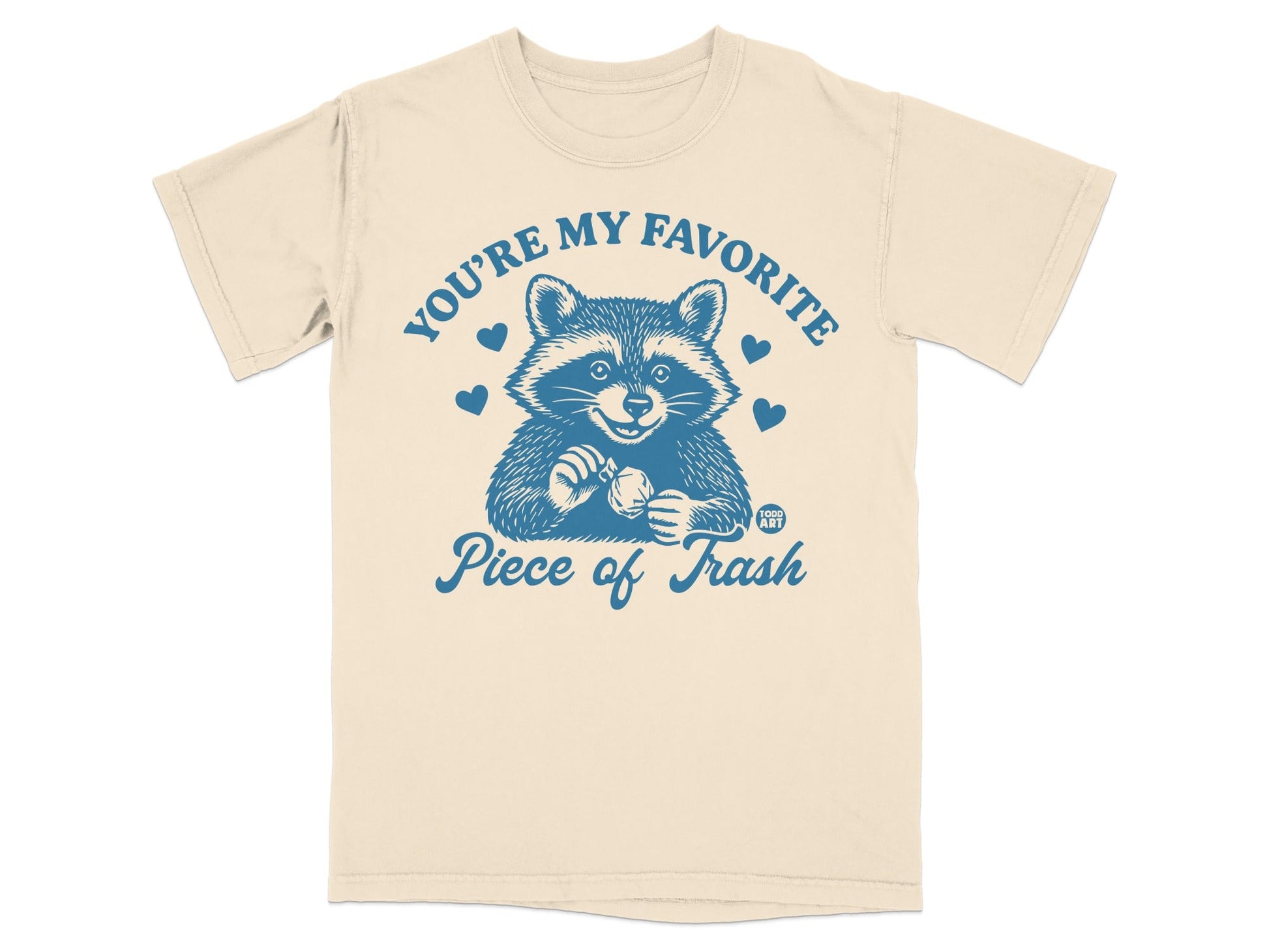 T-shirt with raccoon holding a heart and "You're my favorite piece of trash" text.