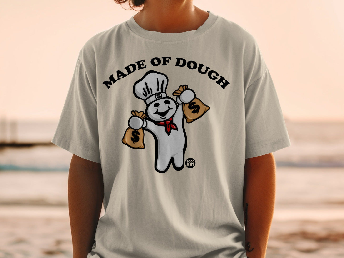 Pillsbury Doughboy wearing chef hat, holding money bags, text "MADE OF DOUGH".