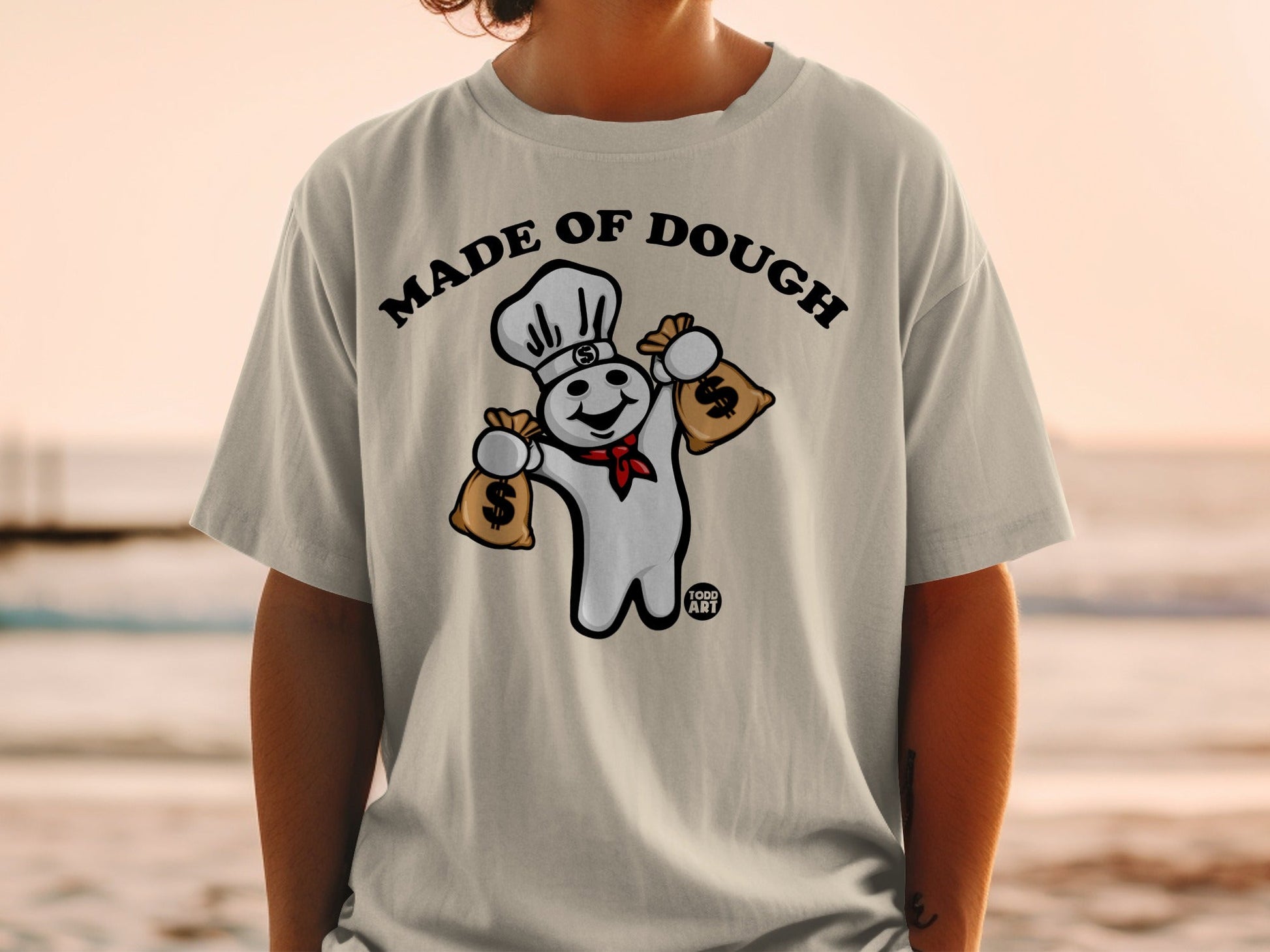 Pillsbury Doughboy wearing chef hat, holding money bags, text "MADE OF DOUGH".
