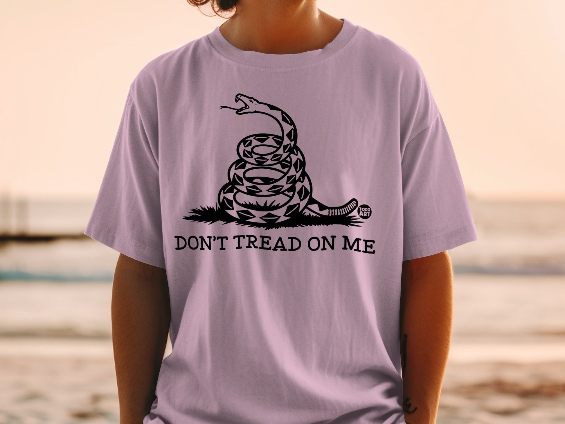 Purple t-shirt with coiled rattlesnake and "Don't Tread On Me" text.