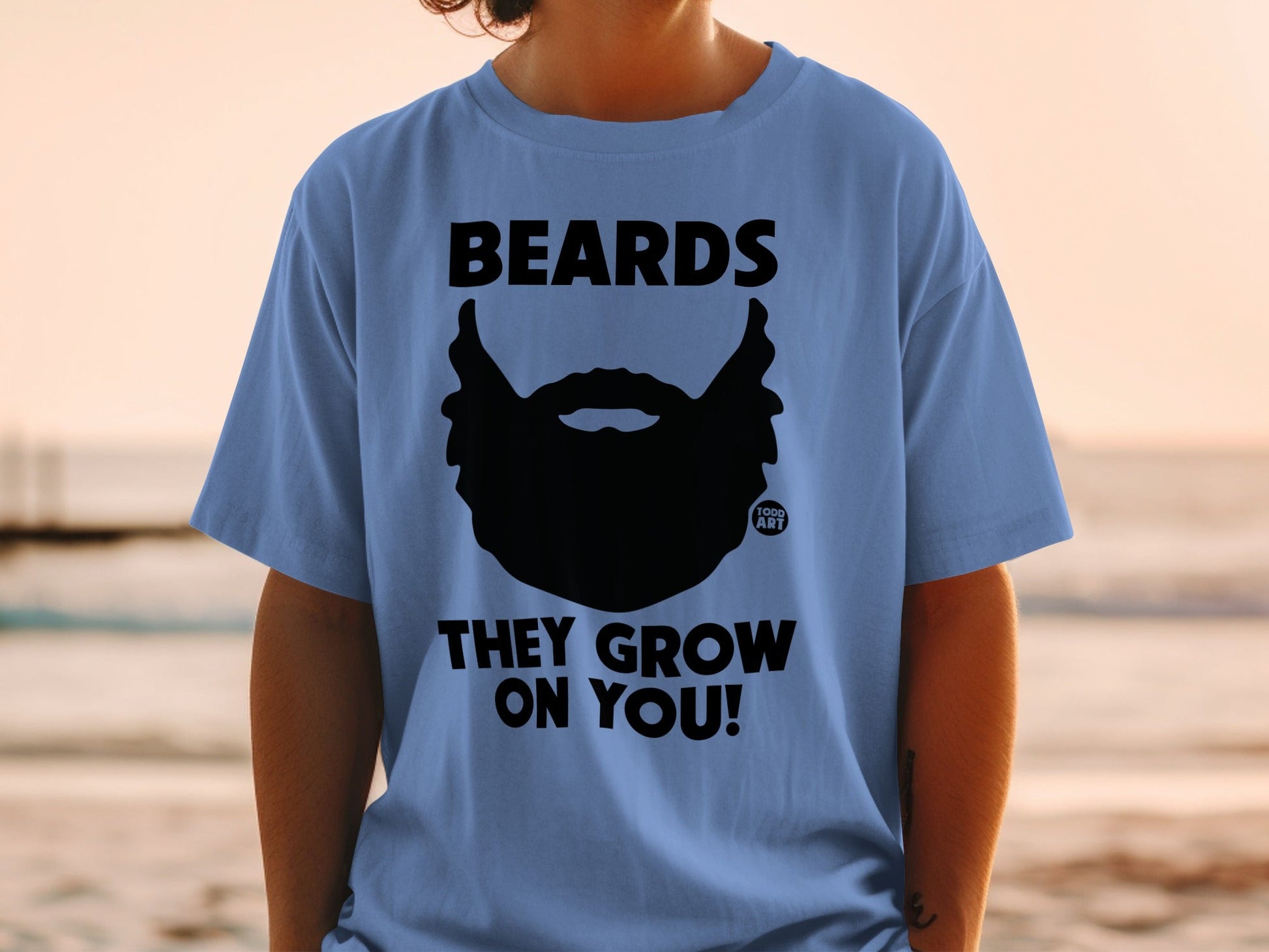 Blue t-shirt with black beard graphic and text "BEARDS THEY GROW ON YOU!"