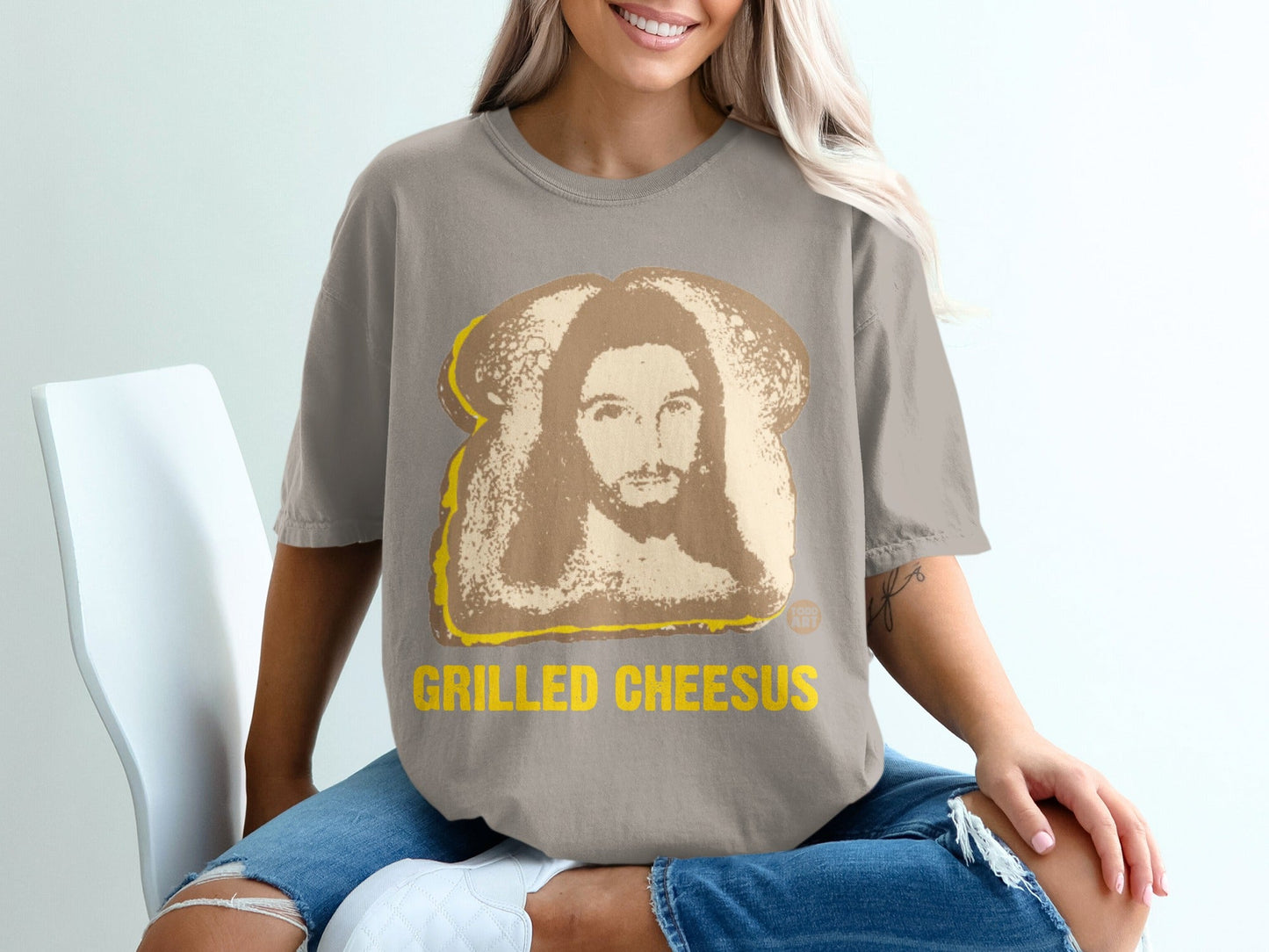 Grey t-shirt with "Grilled Cheesus" text and Jesus face on toast graphic.