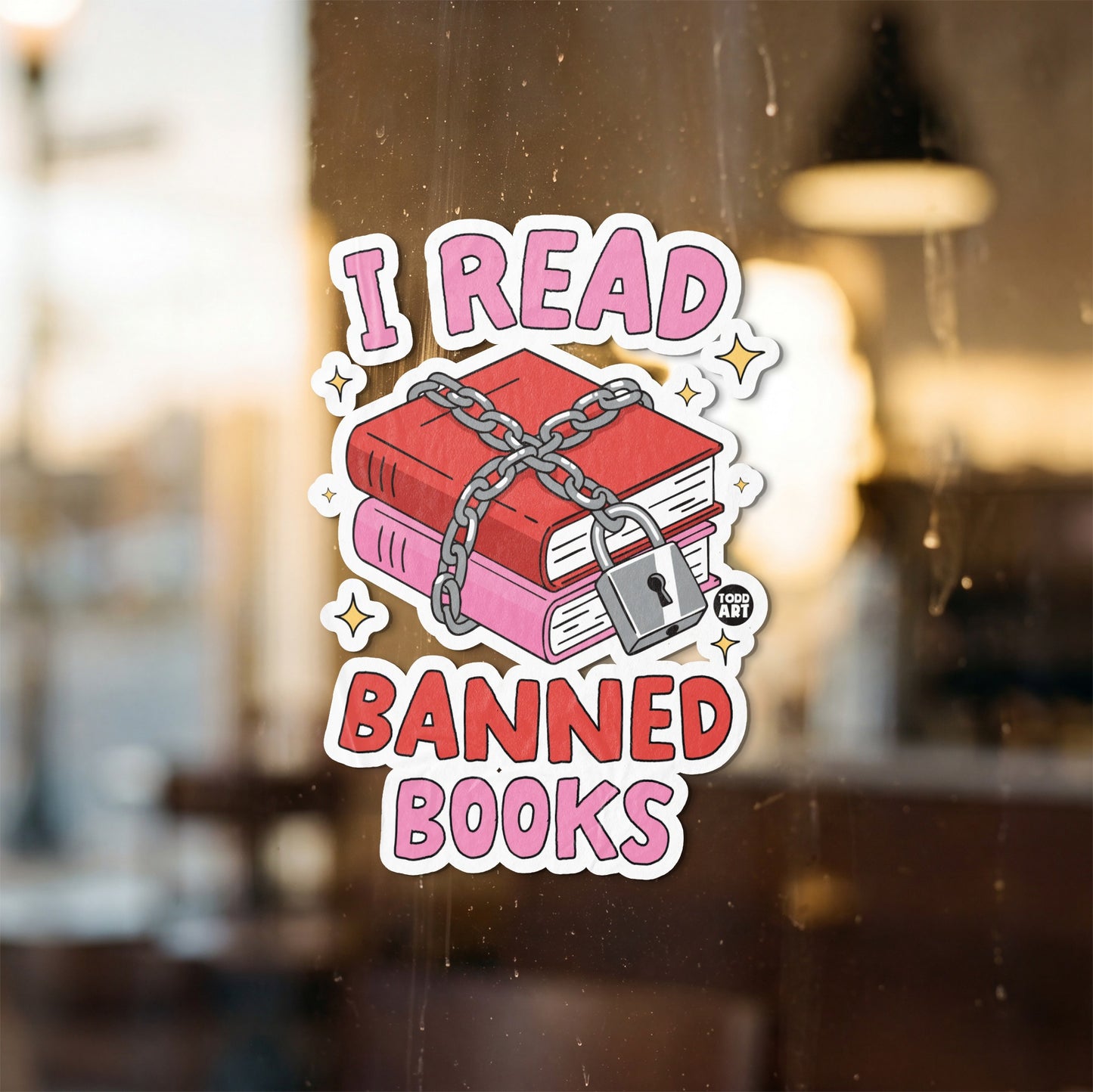 Sticker with pink text "I READ BANNED BOOKS" over chained books and a padlock.