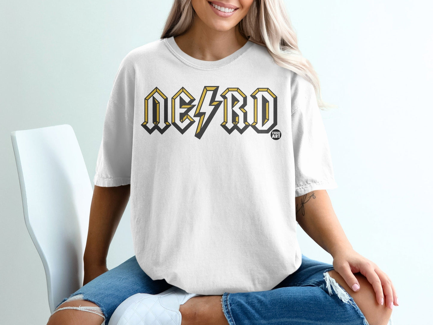 White t-shirt with "NERD" in yellow and black lightning bolt font.