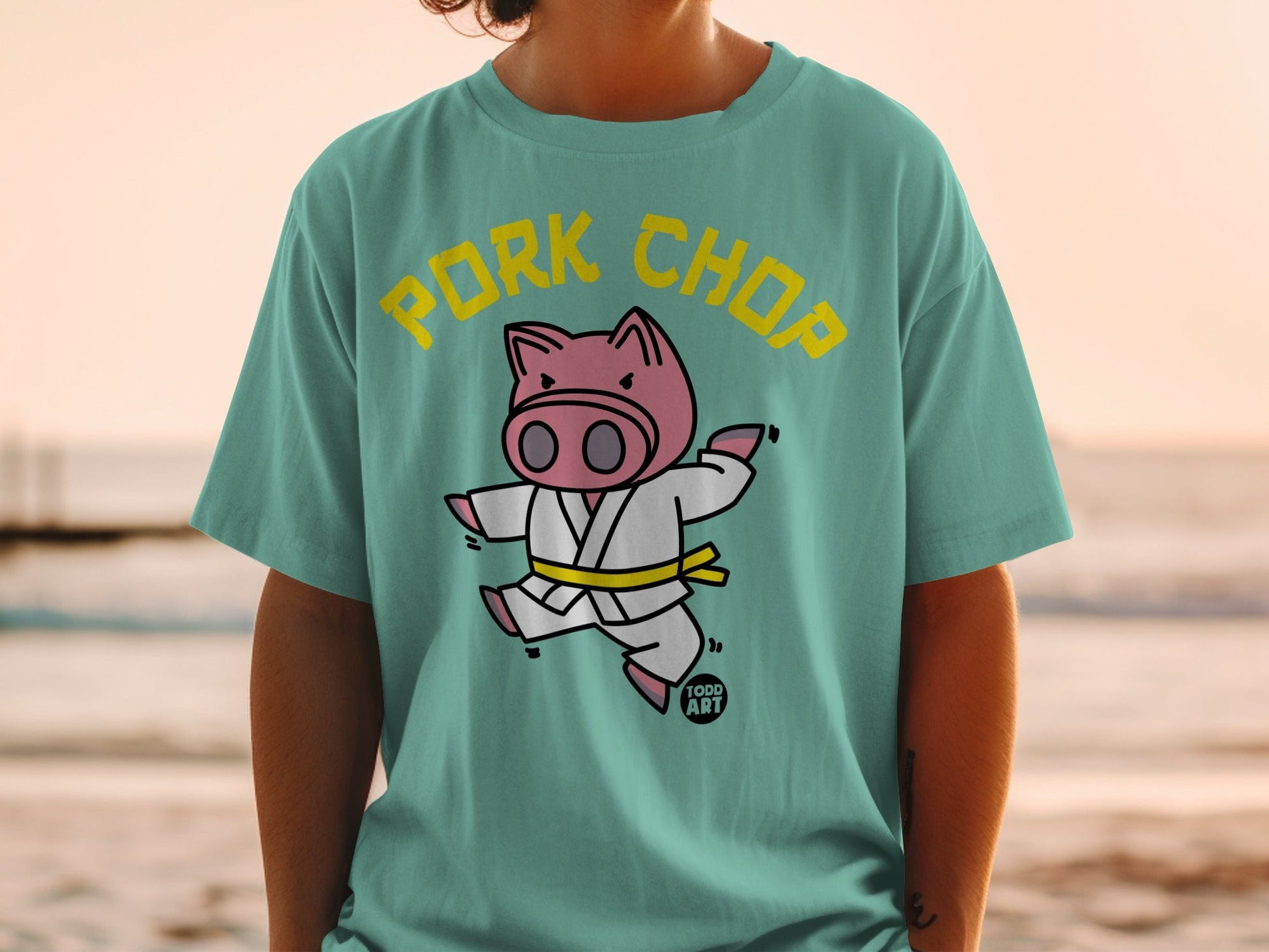 Cartoon pig in a karate gi with "PORK CHOP" text.