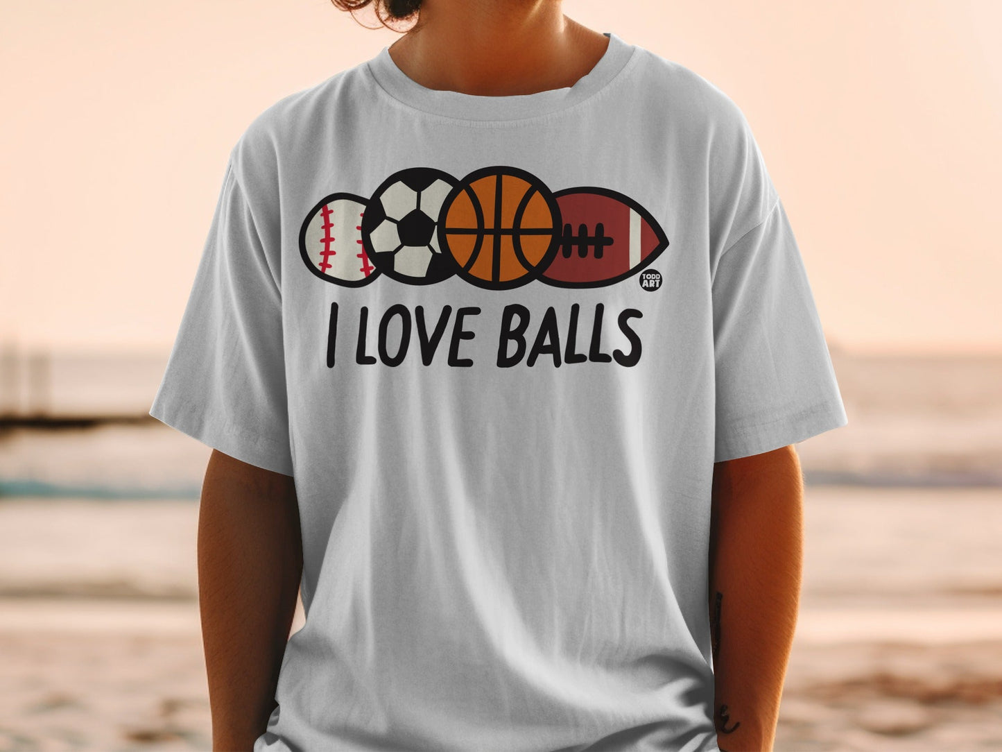 White t-shirt with "I LOVE BALLS" and baseball, basketball, football, and rugby ball graphic.