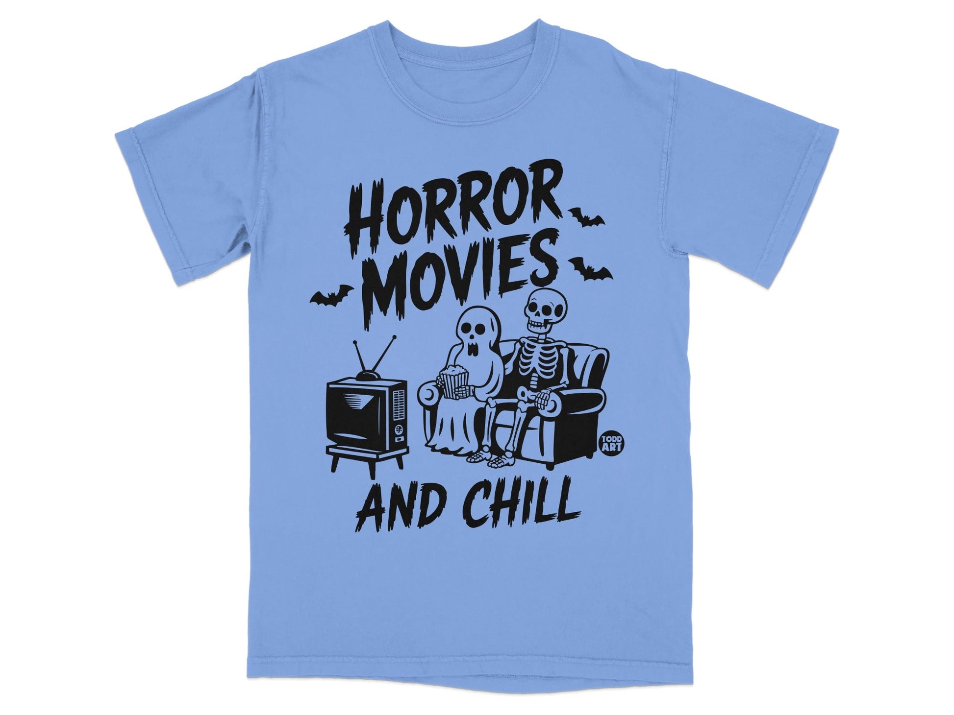 T-shirt with black text "Horror Movies And Chill" featuring skeletons watching TV.