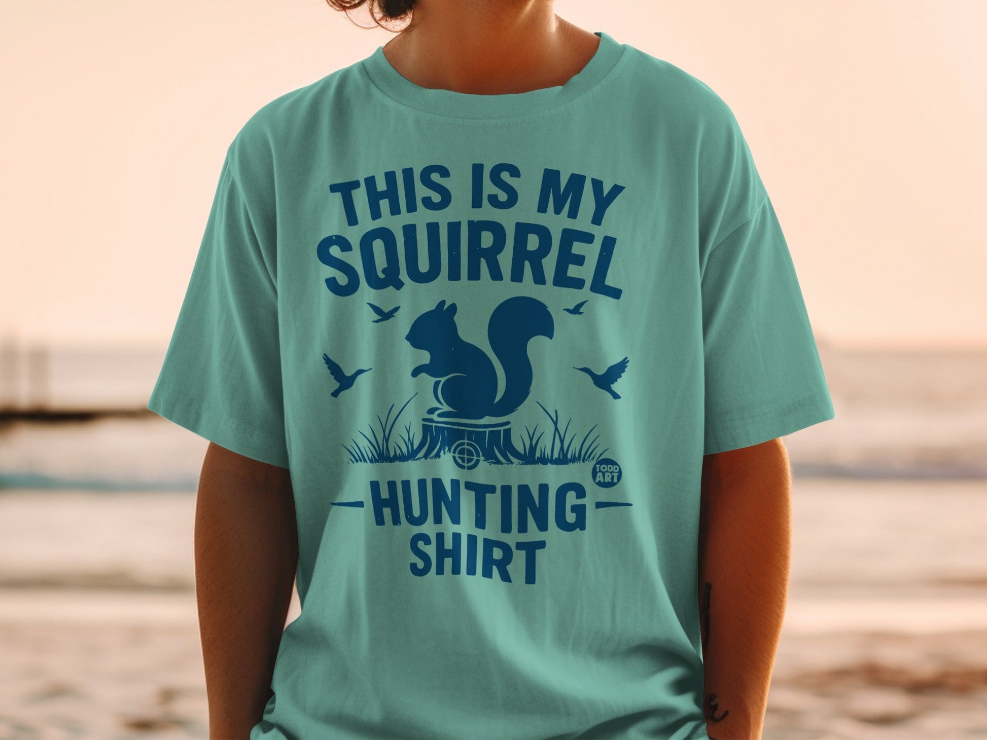 Teal t-shirt with "This is my Squirrel Hunting Shirt" and squirrel graphic.