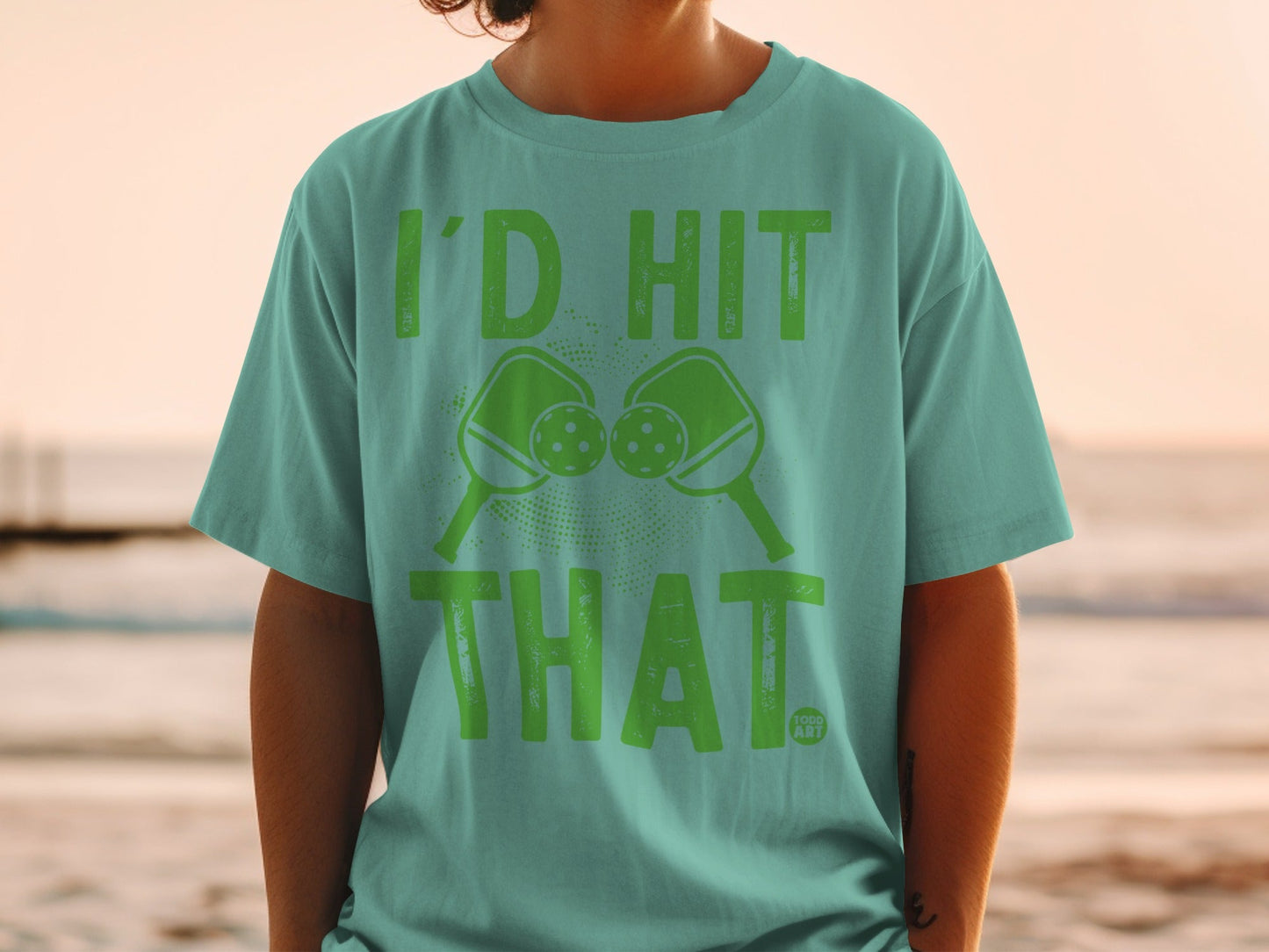Teal t-shirt with "I'D HIT THAT." and pickleball paddles graphic.