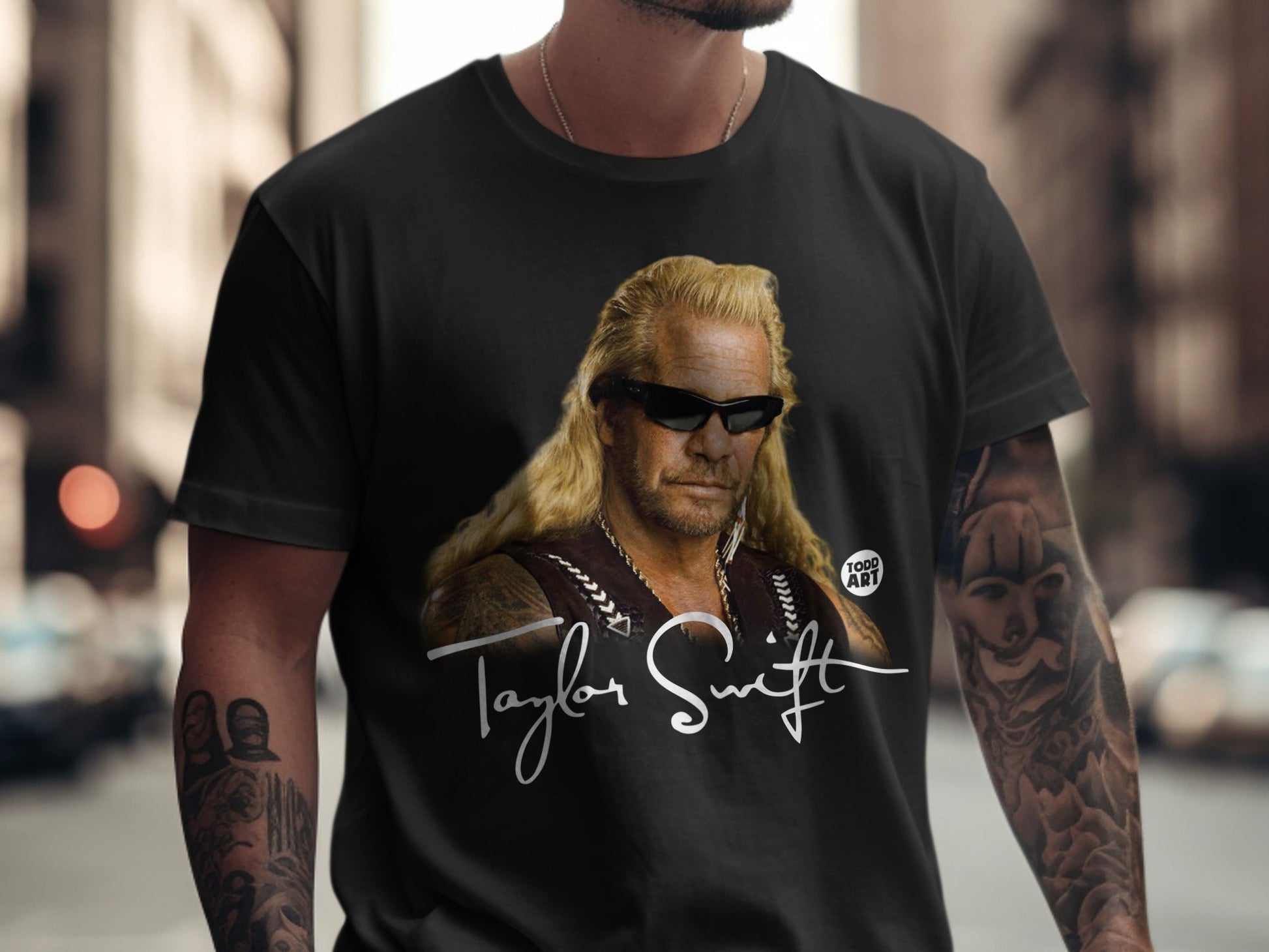 Black t-shirt featuring a portrait of Duane "Dog" Chapman and "Taylor Swift" signature.