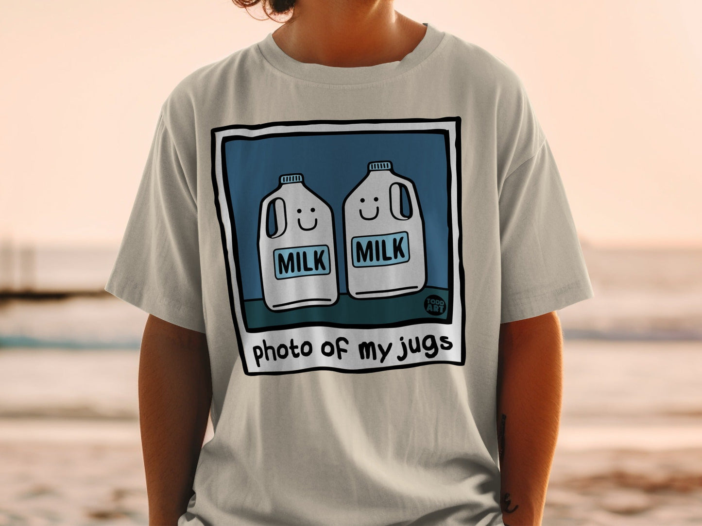 T-shirt graphic with two smiling milk jugs and text "photo of my jugs".
