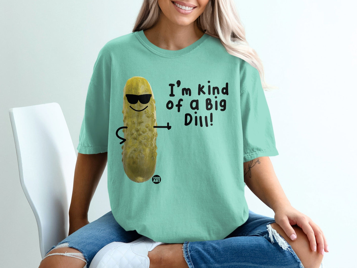 Mint green t-shirt with a cartoon pickle wearing sunglasses saying "I'm kind of a Big Dill!"