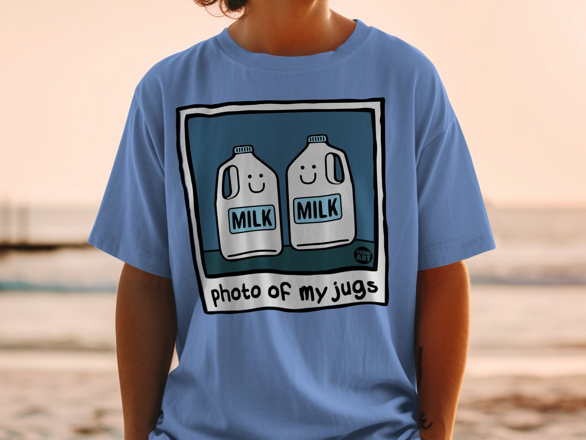 Blue t-shirt with cartoon milk jugs and "photo of my jugs" text.