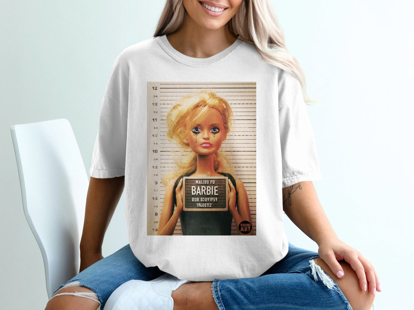 T-shirt graphic of a Barbie mugshot from Malibu PD.