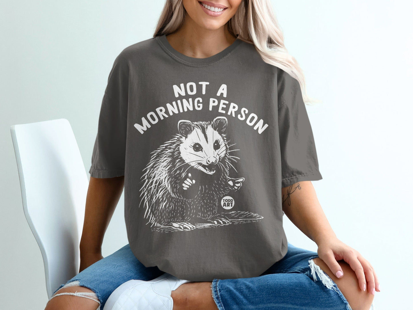 T-shirt with possum graphic and "Not a morning person" text.