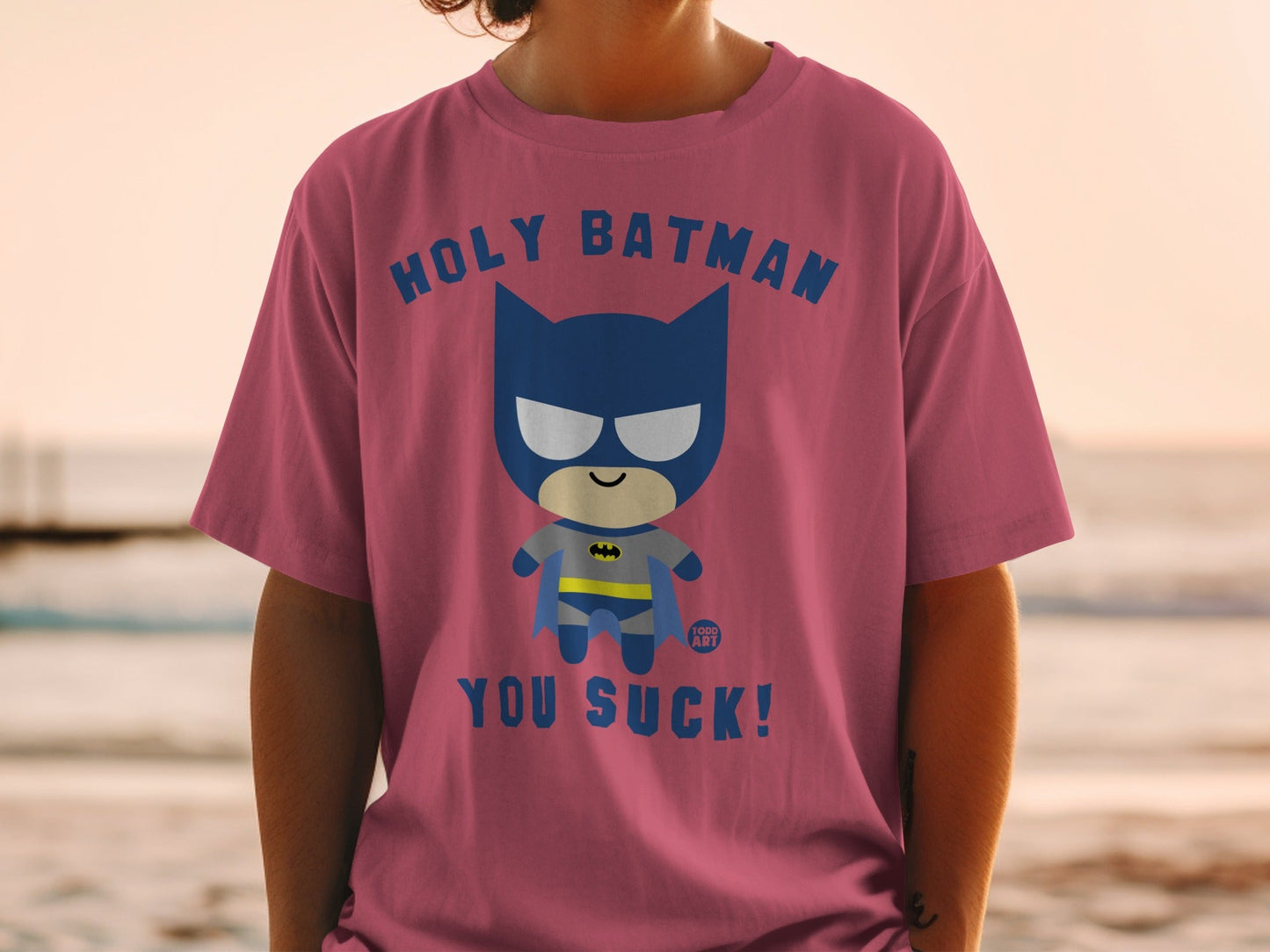 Pink t-shirt with "Holy Batman, You Suck!" text and cartoon Batman graphic.