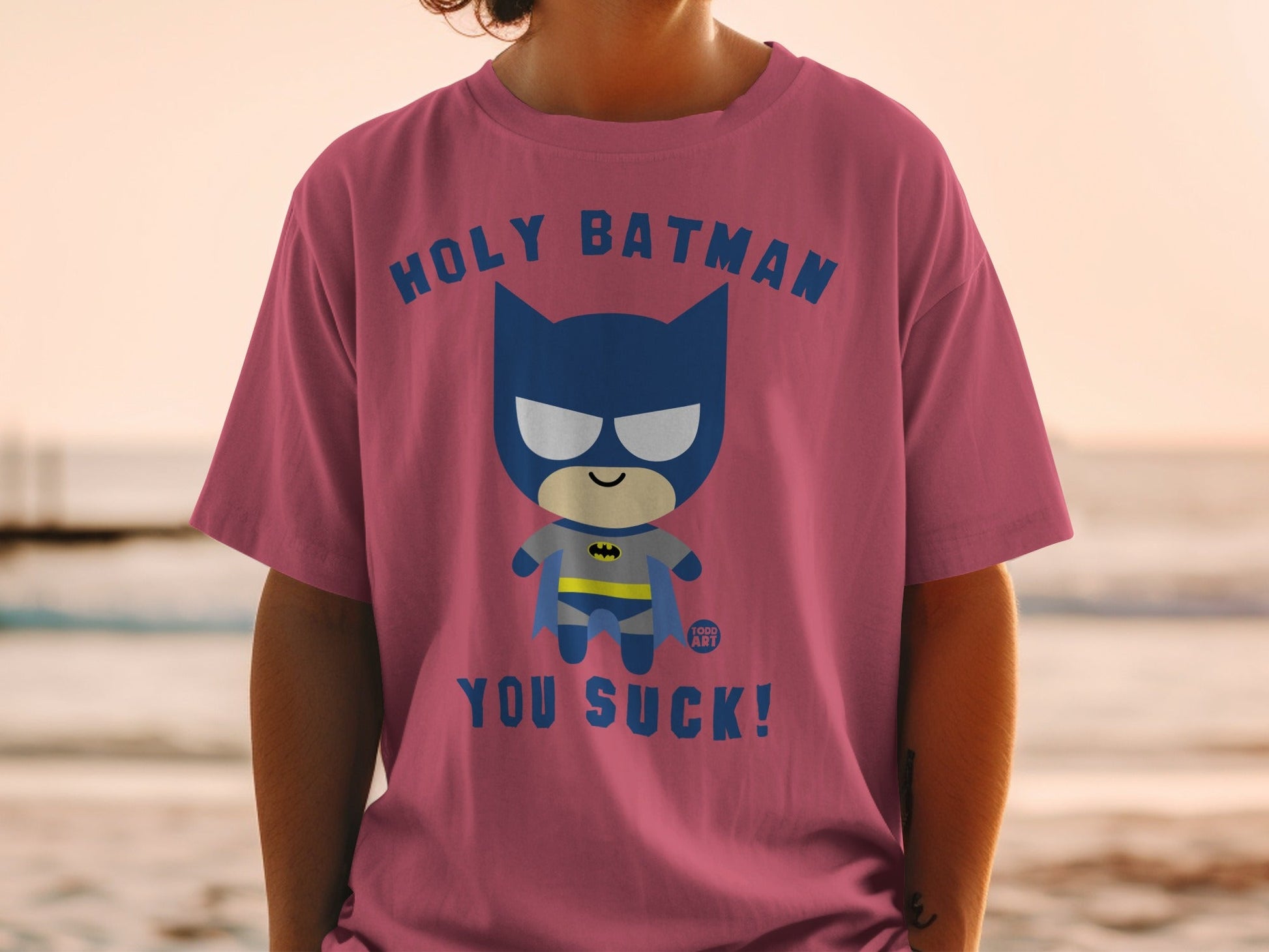 Pink t-shirt with "Holy Batman, You Suck!" text and cartoon Batman graphic.