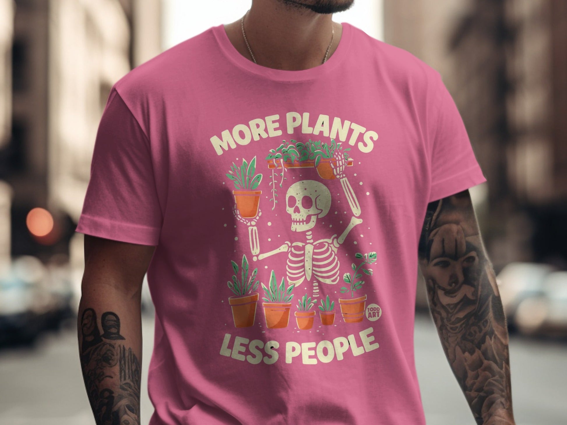 Skeleton wearing pink t-shirt with "More Plants Less People" graphic.