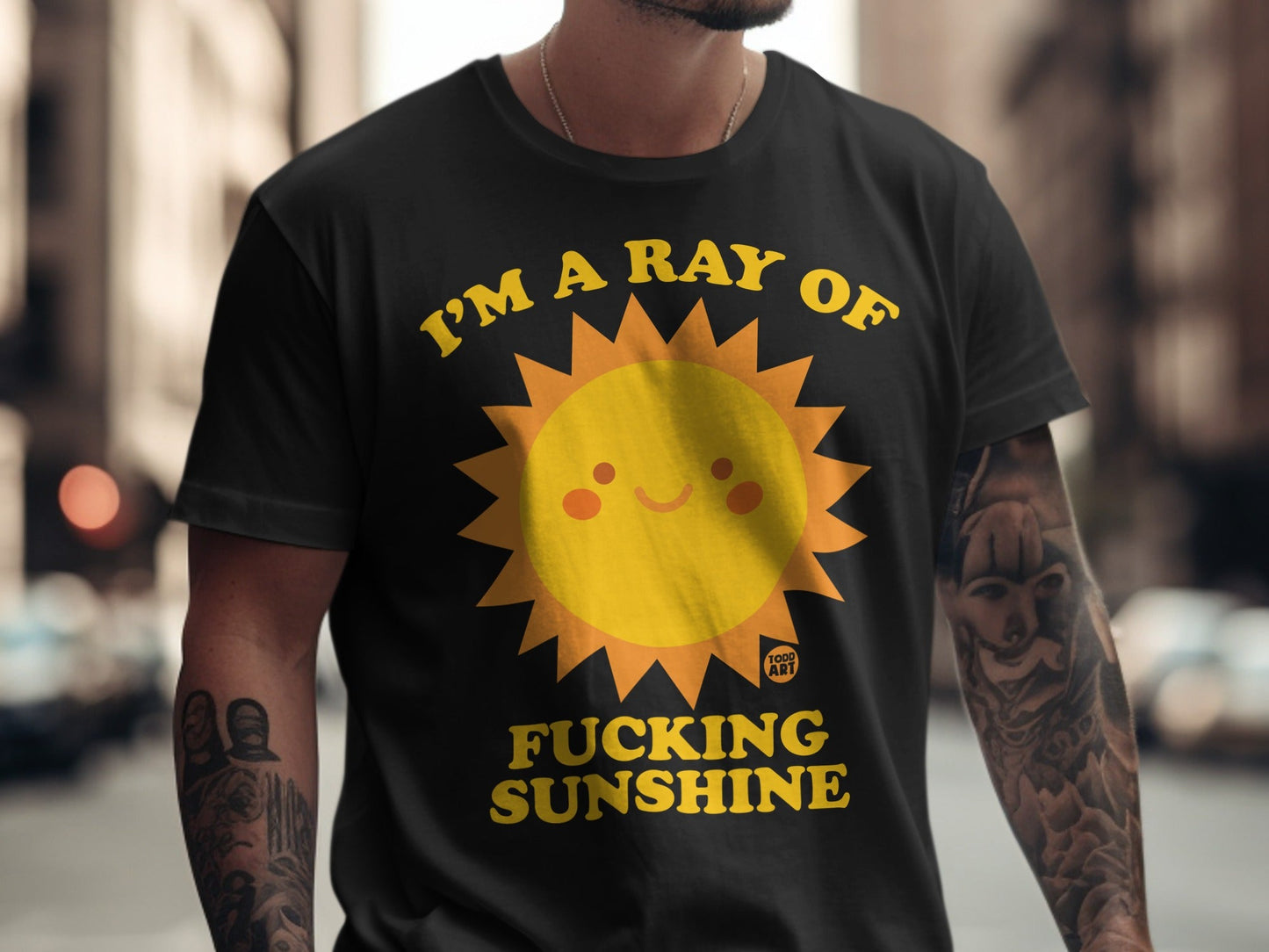 Black t-shirt with "I'm a ray of fucking sunshine" and a sun graphic.
