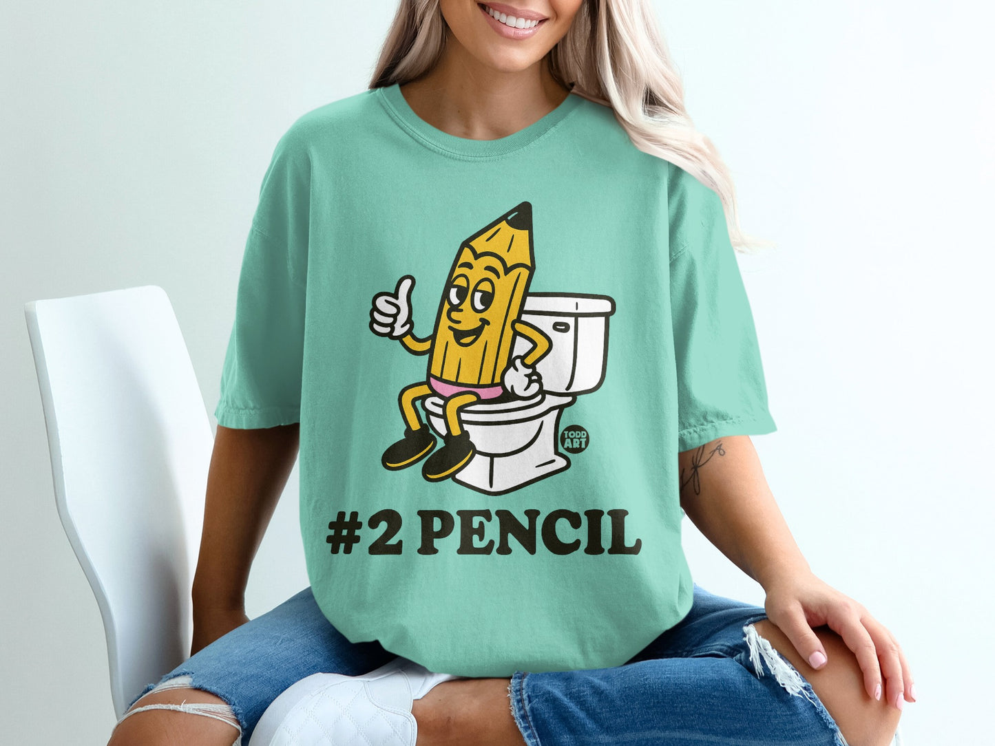 T-shirt graphic of a #2 pencil giving a thumbs up while sitting on a toilet.