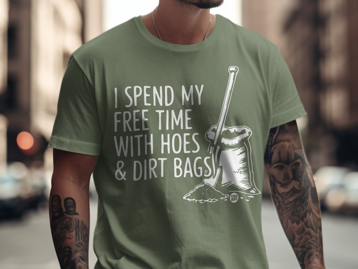 Green t-shirt with white text and graphic of a sack of dirt and a hoe.