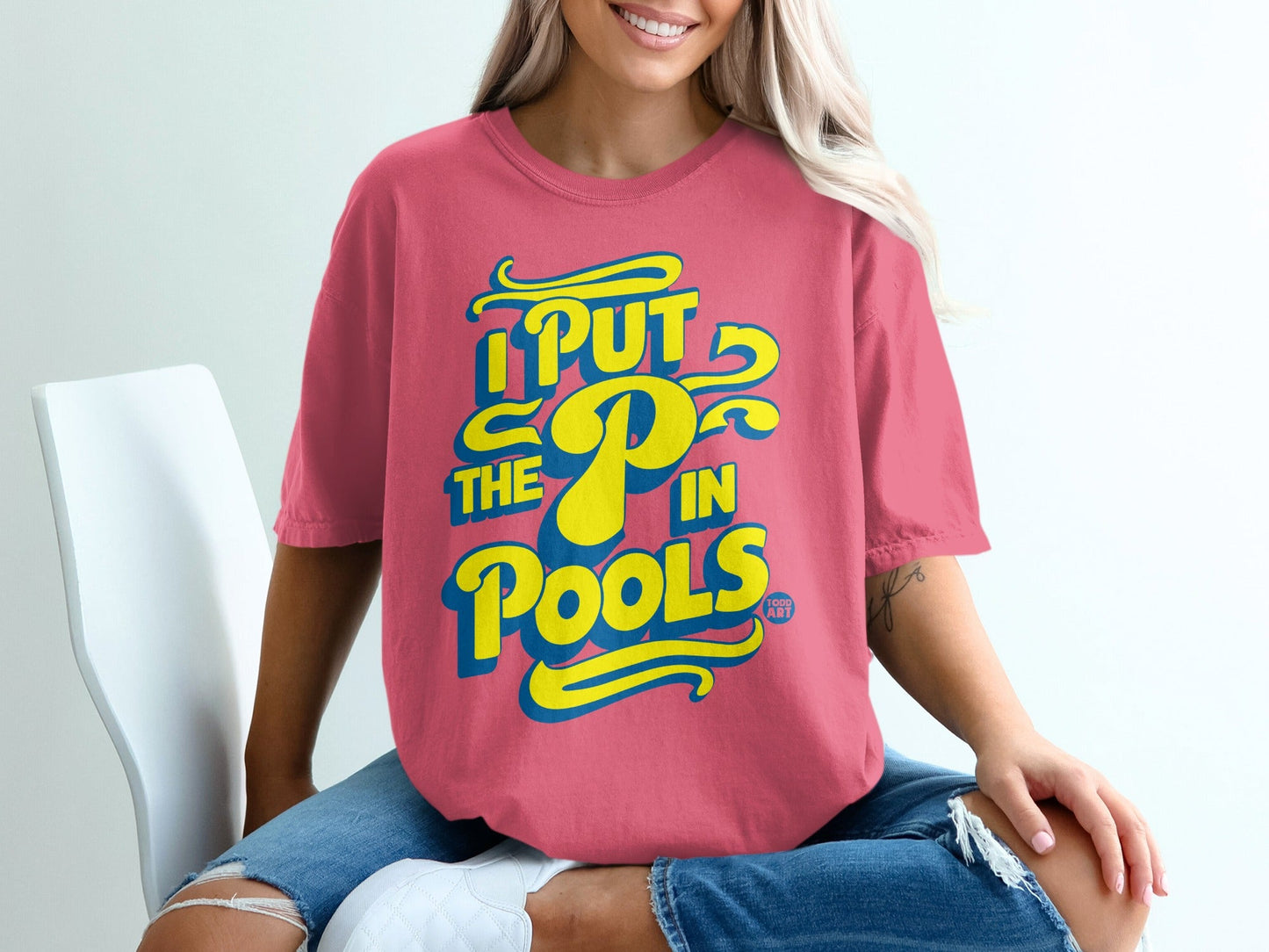 Pink t-shirt with blue "I put the P in pools" text and yellow accents.