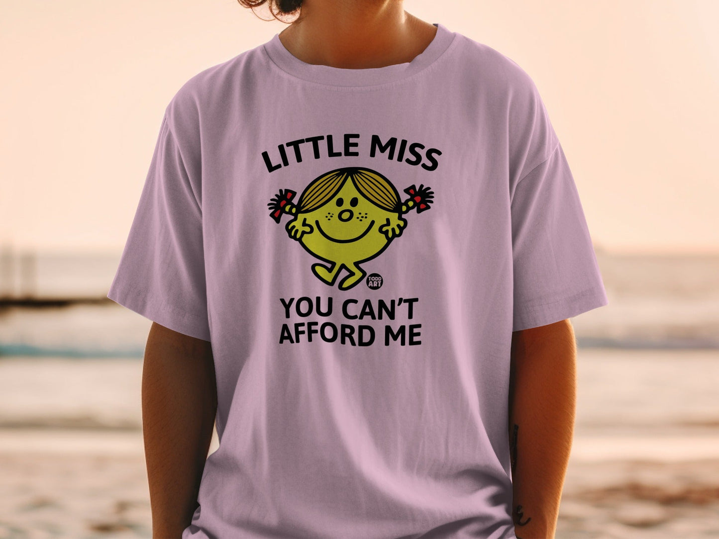 Lilac t-shirt with "Little Miss You Can't Afford Me" graphic.
