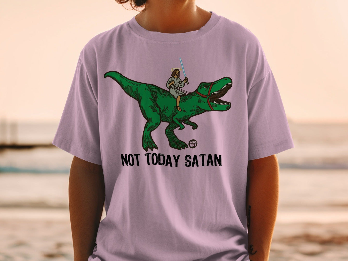 Jesus riding a dinosaur with a lightsaber, text reads "NOT TODAY SATAN".