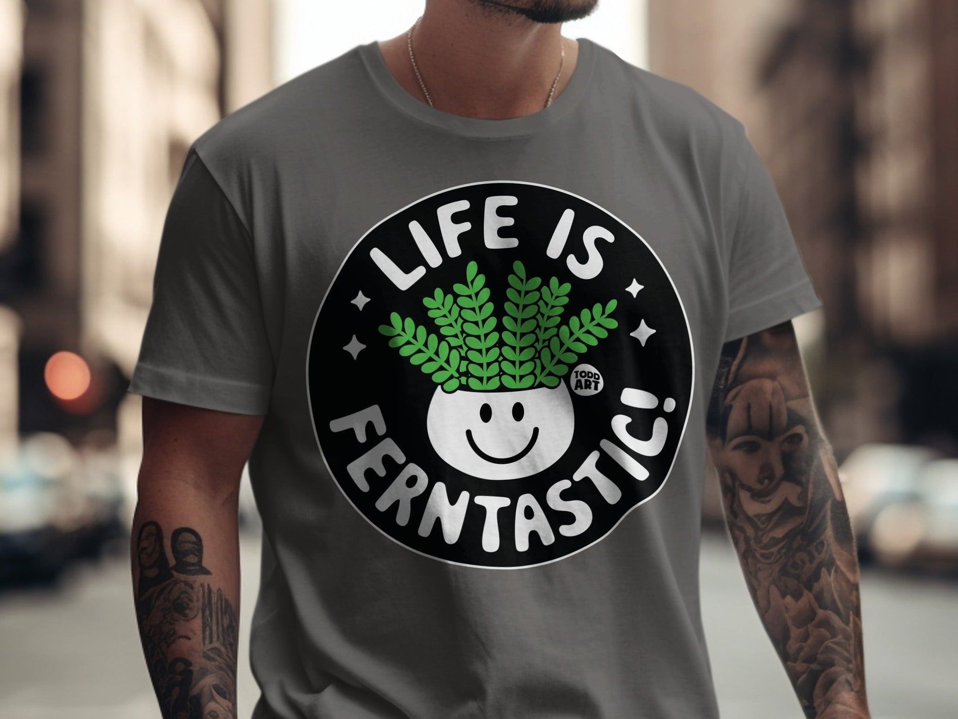 T-shirt with a plant in a pot and text "LIFE IS FERNTASITC!".