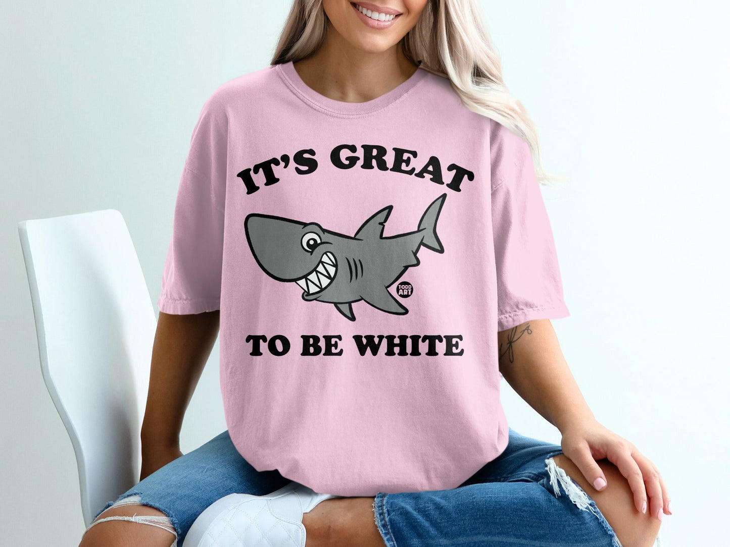 Pink t-shirt with cartoon shark and text "IT'S GREAT TO BE WHITE".