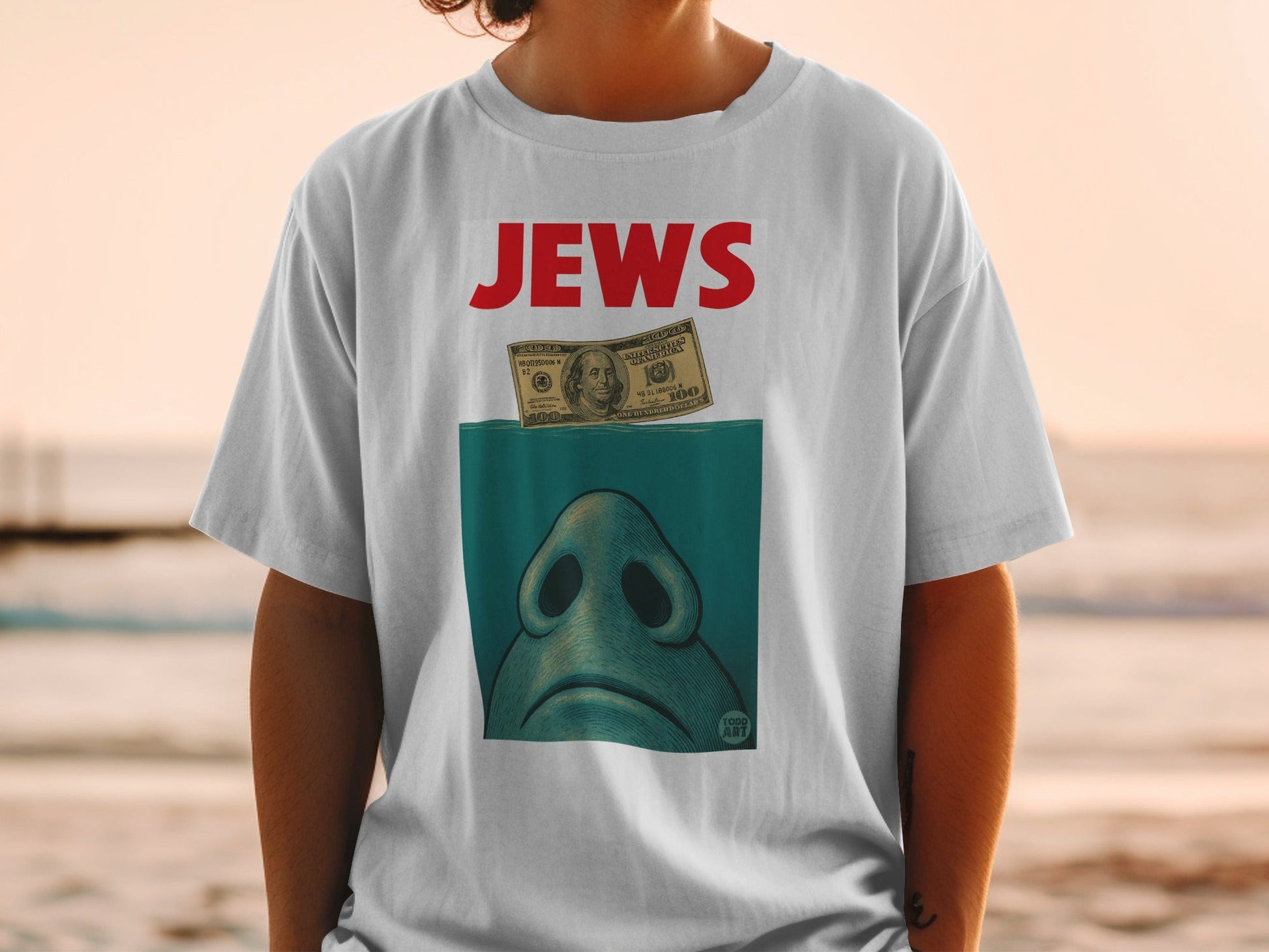 T-shirt with Jaws movie logo, shark nose, and $100 bill.