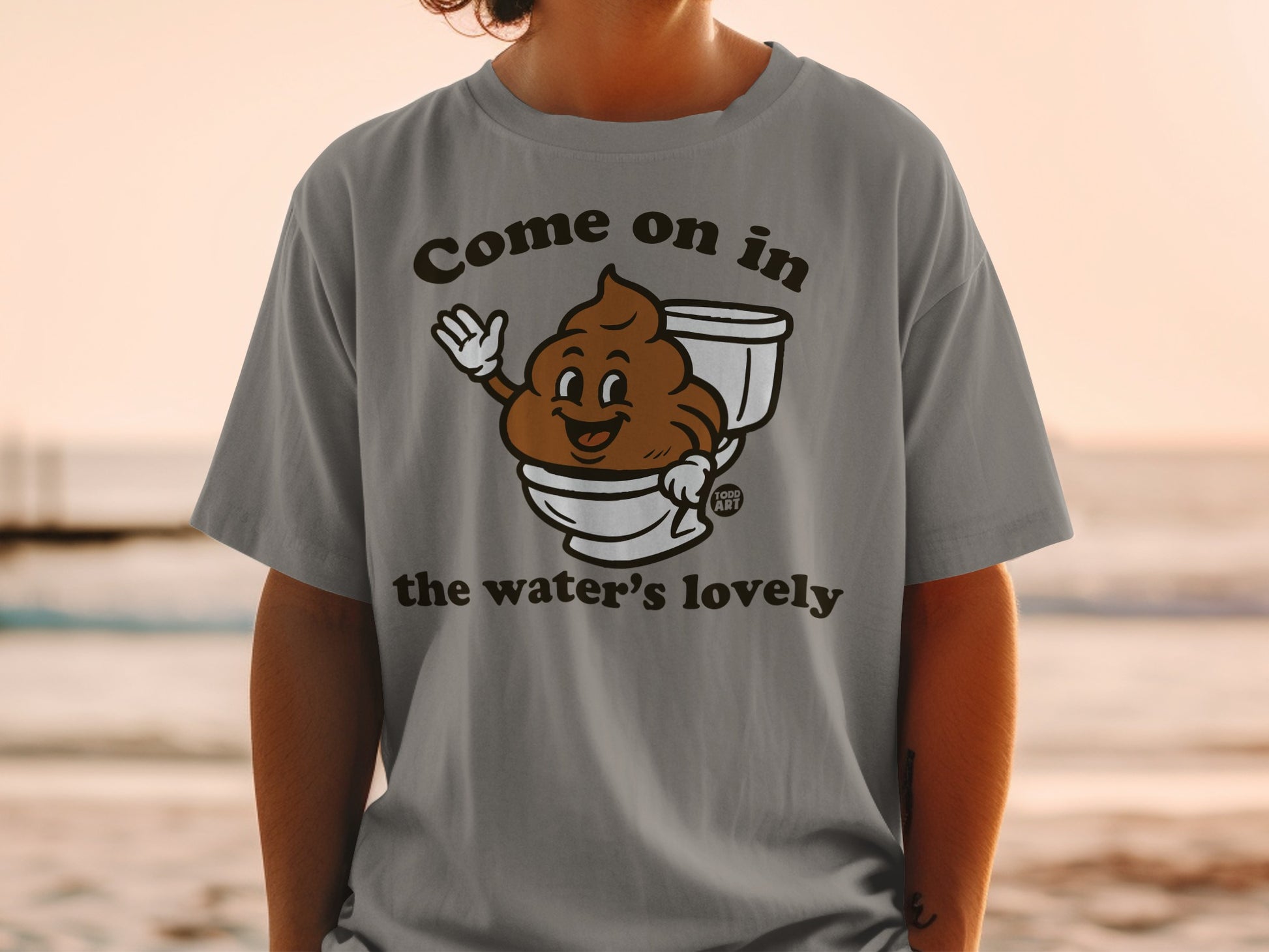 T-shirt with brown cartoon poop in toilet saying "Come on in the water's lovely."