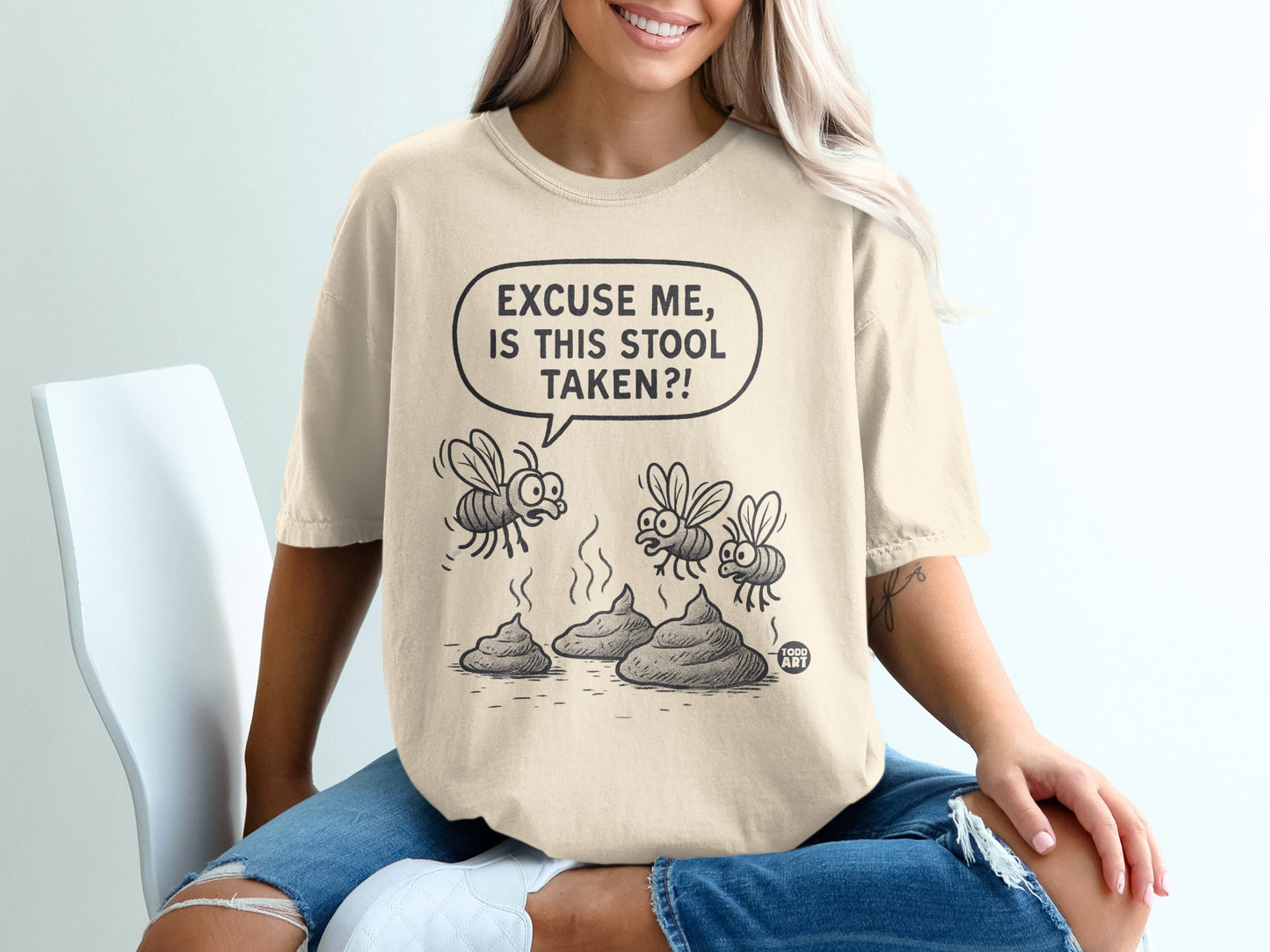 T-shirt with cartoon flies asking "Excuse me, is this stool taken?".