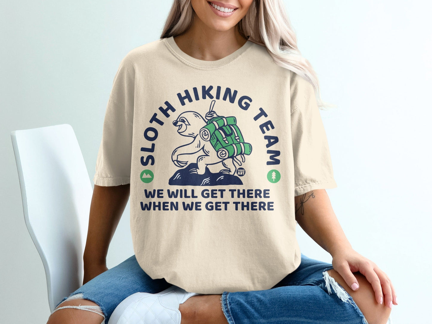 Cream t-shirt with "Sloth Hiking Team" and sloth graphic.