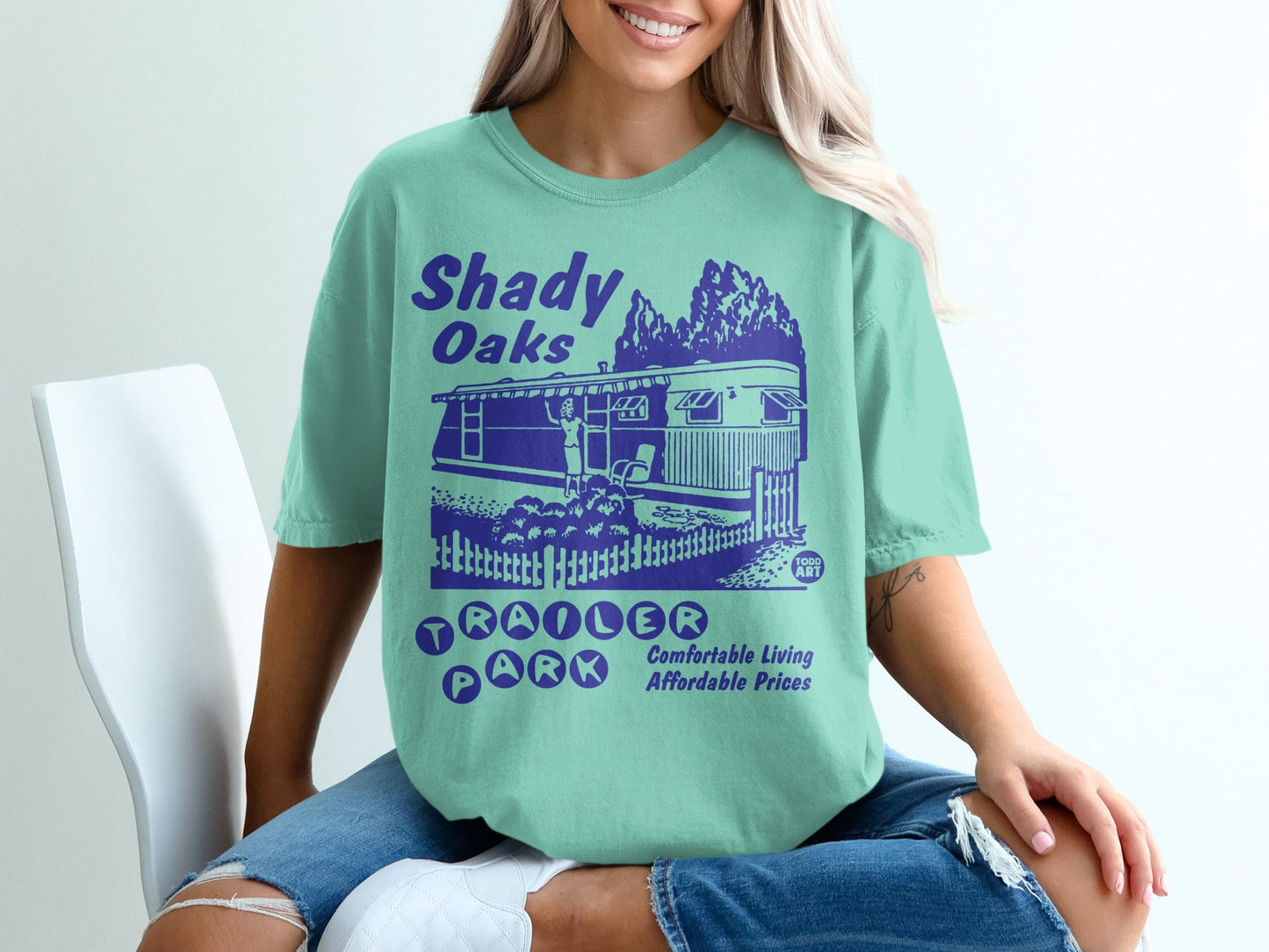 Shady Oaks Trailer Park graphic tee with trees and a trailer home.