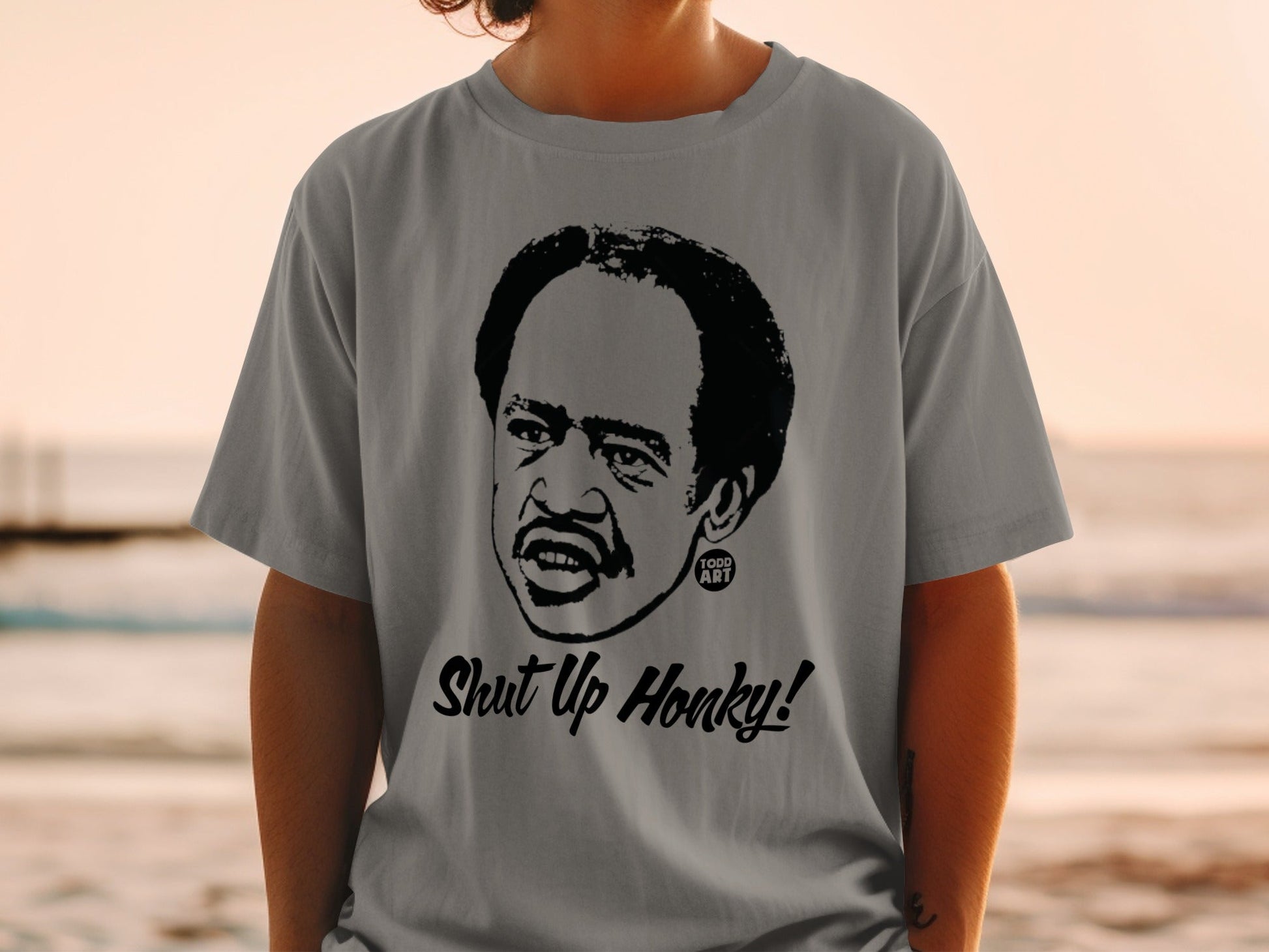 T-shirt featuring a black and white portrait of Richard Pryor with "Shut Up Honky!" text.