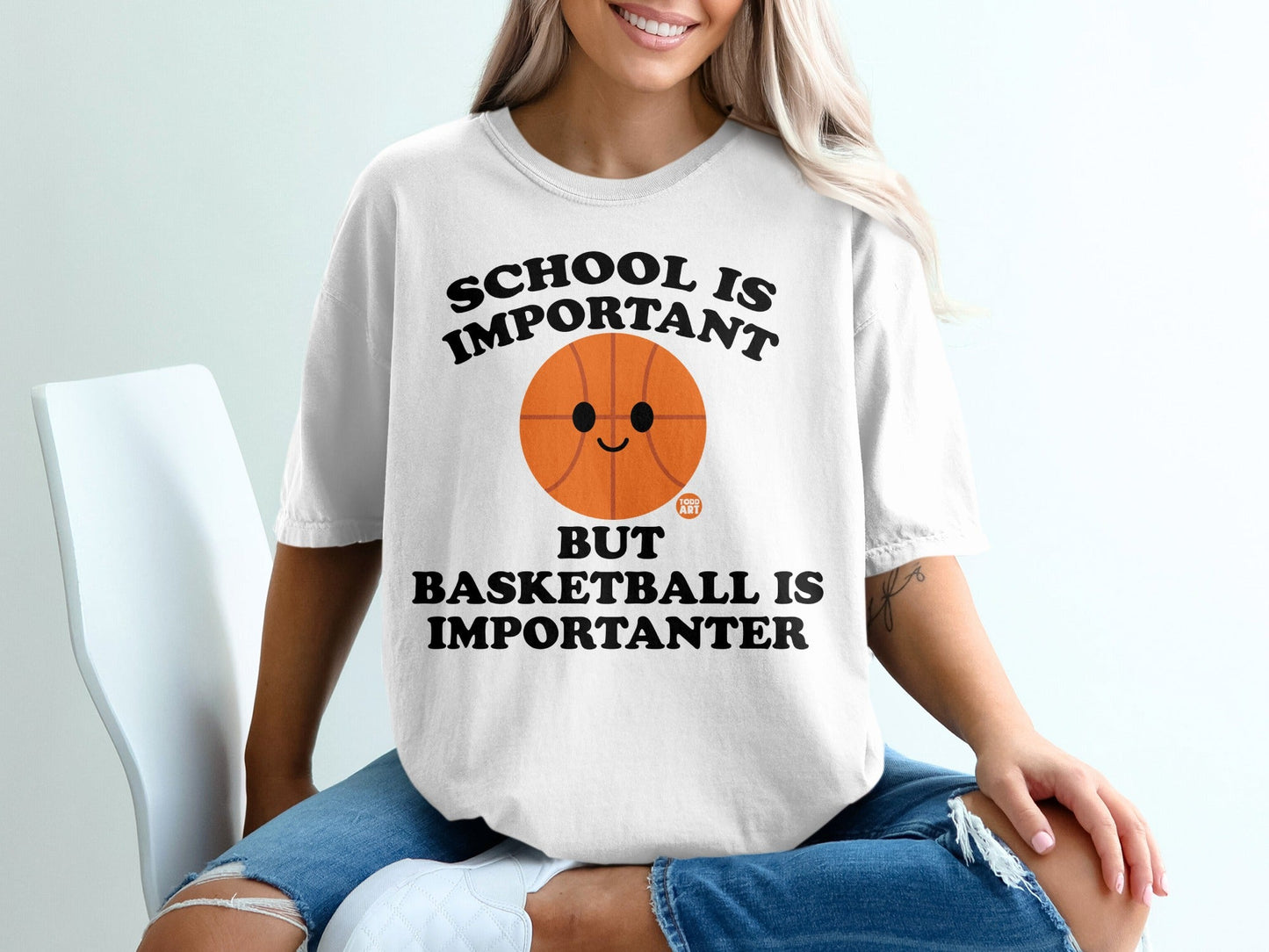 White t-shirt with "School is important but basketball is importanter" and a basketball graphic.