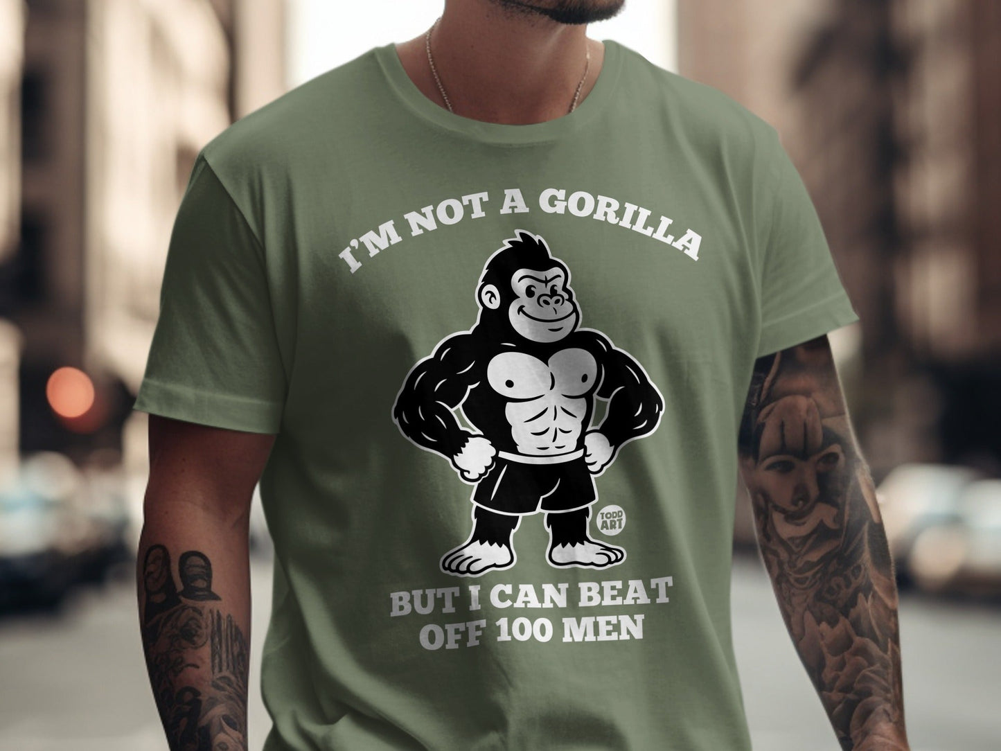 Green t-shirt with cartoon gorilla and text "I'M NOT A GORILLA BUT I CAN BEAT OFF 100 MEN".
