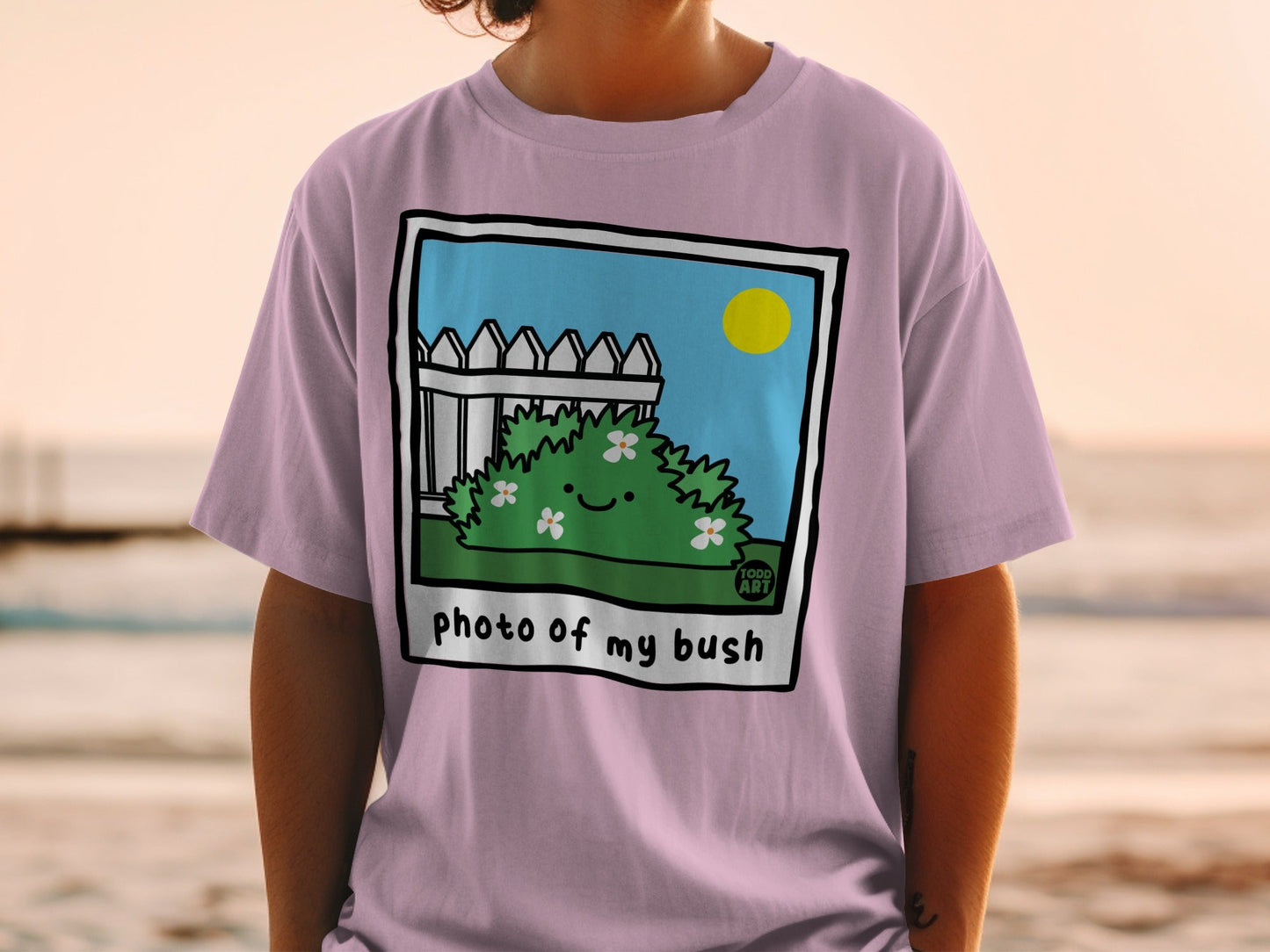 Illustration of a cartoon bush with flowers, a fence, and a sun, text "photo of my bush".