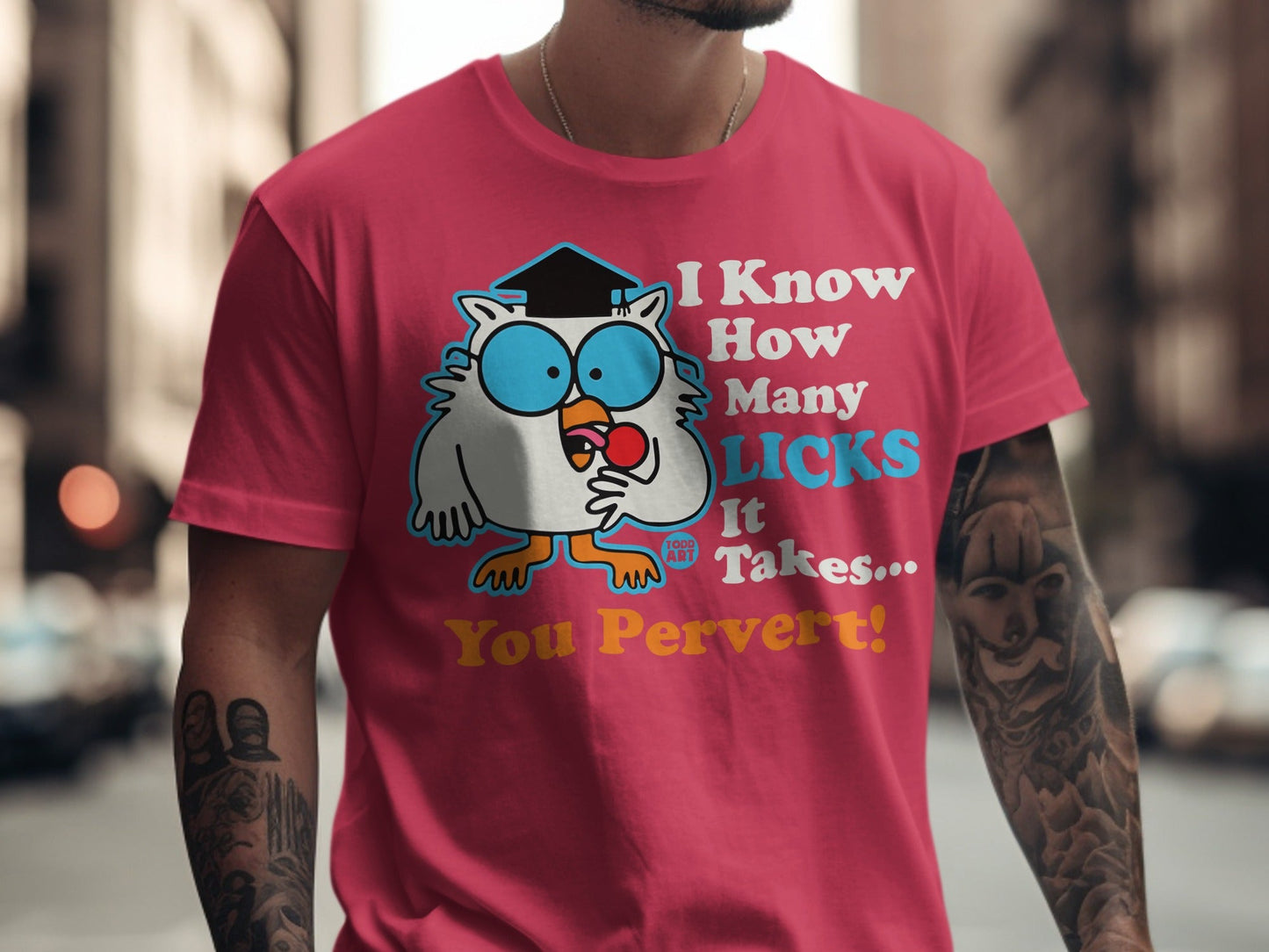 Pink t-shirt with cartoon owl asking "How Many Licks It Takes You Pervert!"