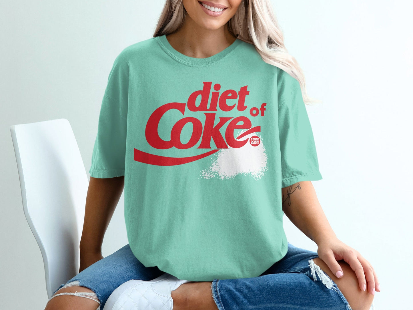 Diet Coke graphic t-shirt with red logo and sugar-like powder detail.