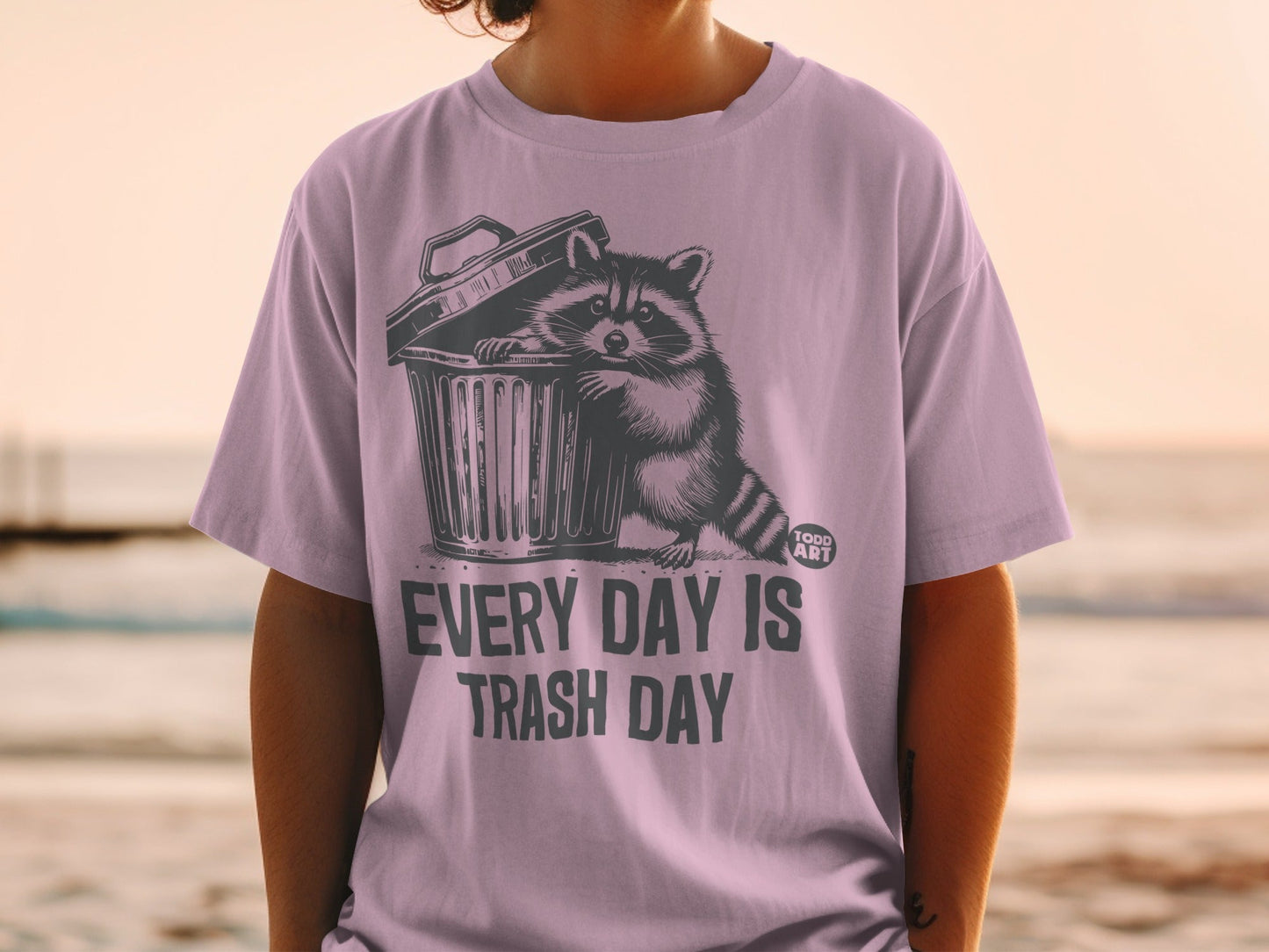 T-shirt with raccoon in trash can and "EVERY DAY IS TRASH DAY" text.