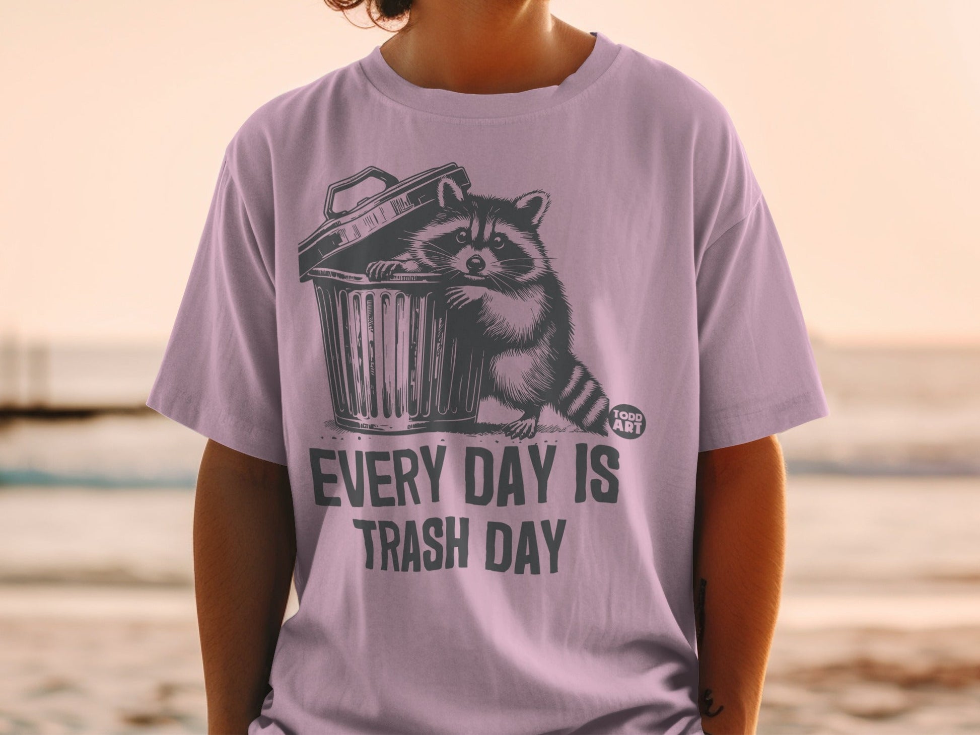 T-shirt with raccoon in trash can and "EVERY DAY IS TRASH DAY" text.